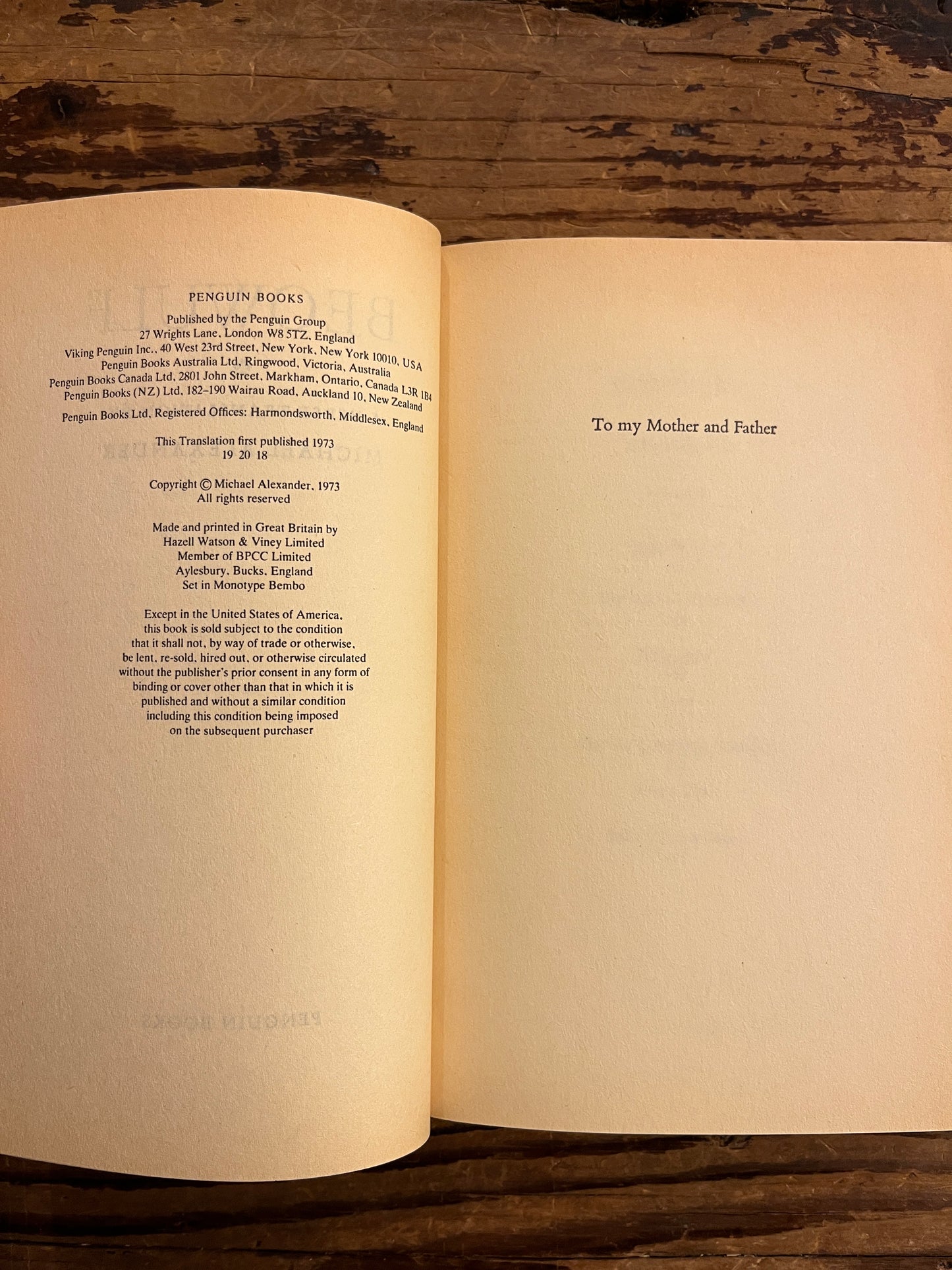 Open book on a wooden surface with the title details visible 