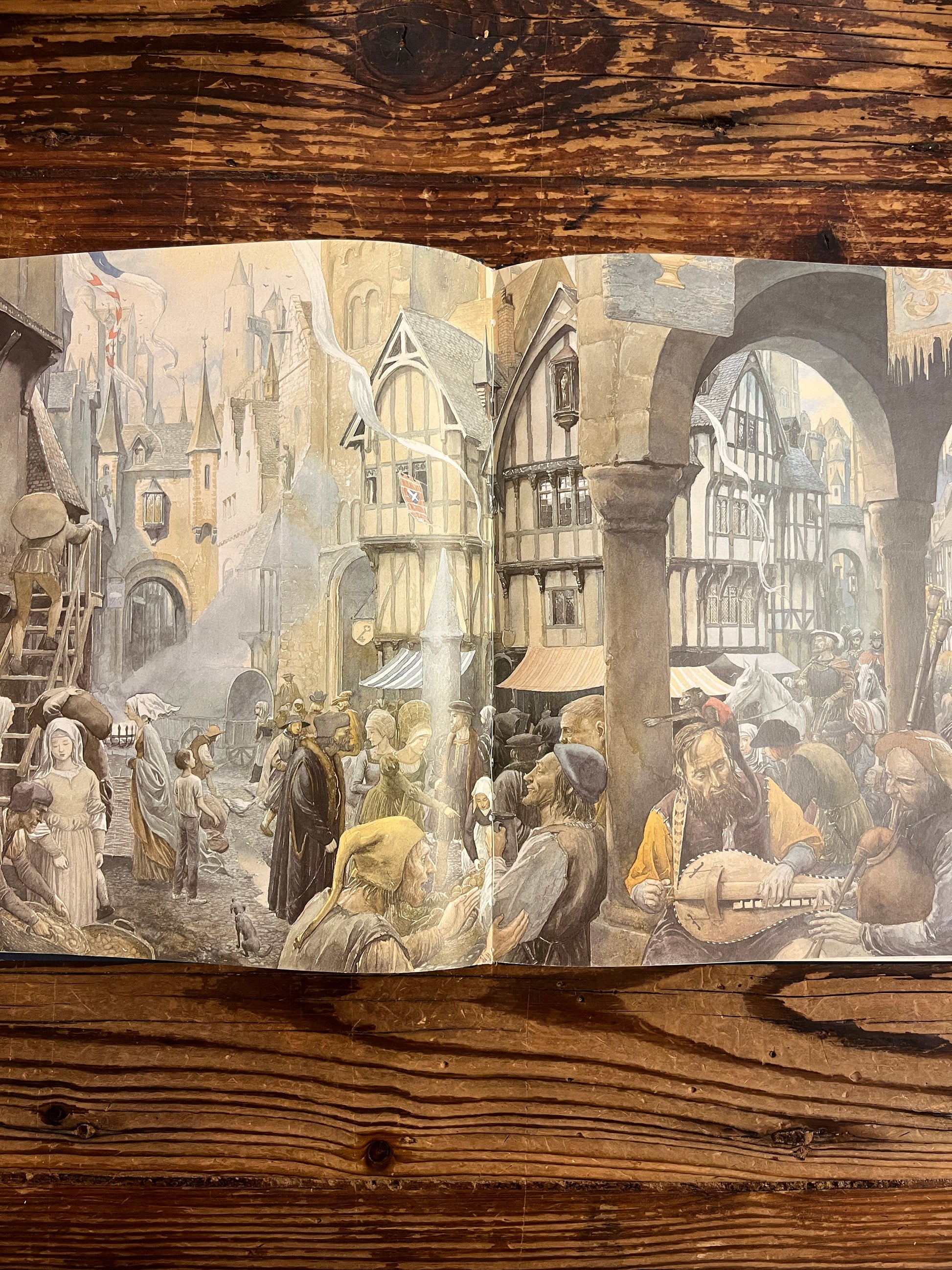 open book titled 'The Mirrorstone' showing a drawing from Alan Lee on a wooden surface