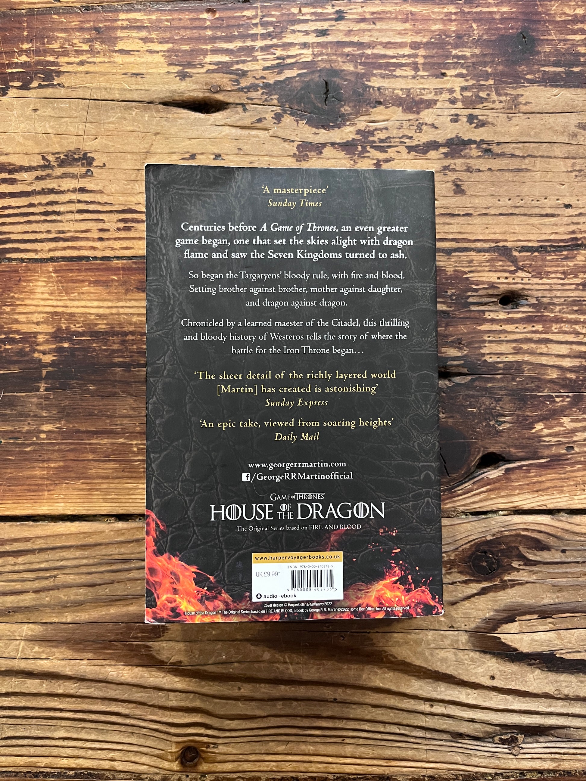 Book titled 'Fire and Blood' by George R.R. Martin on a wooden surface