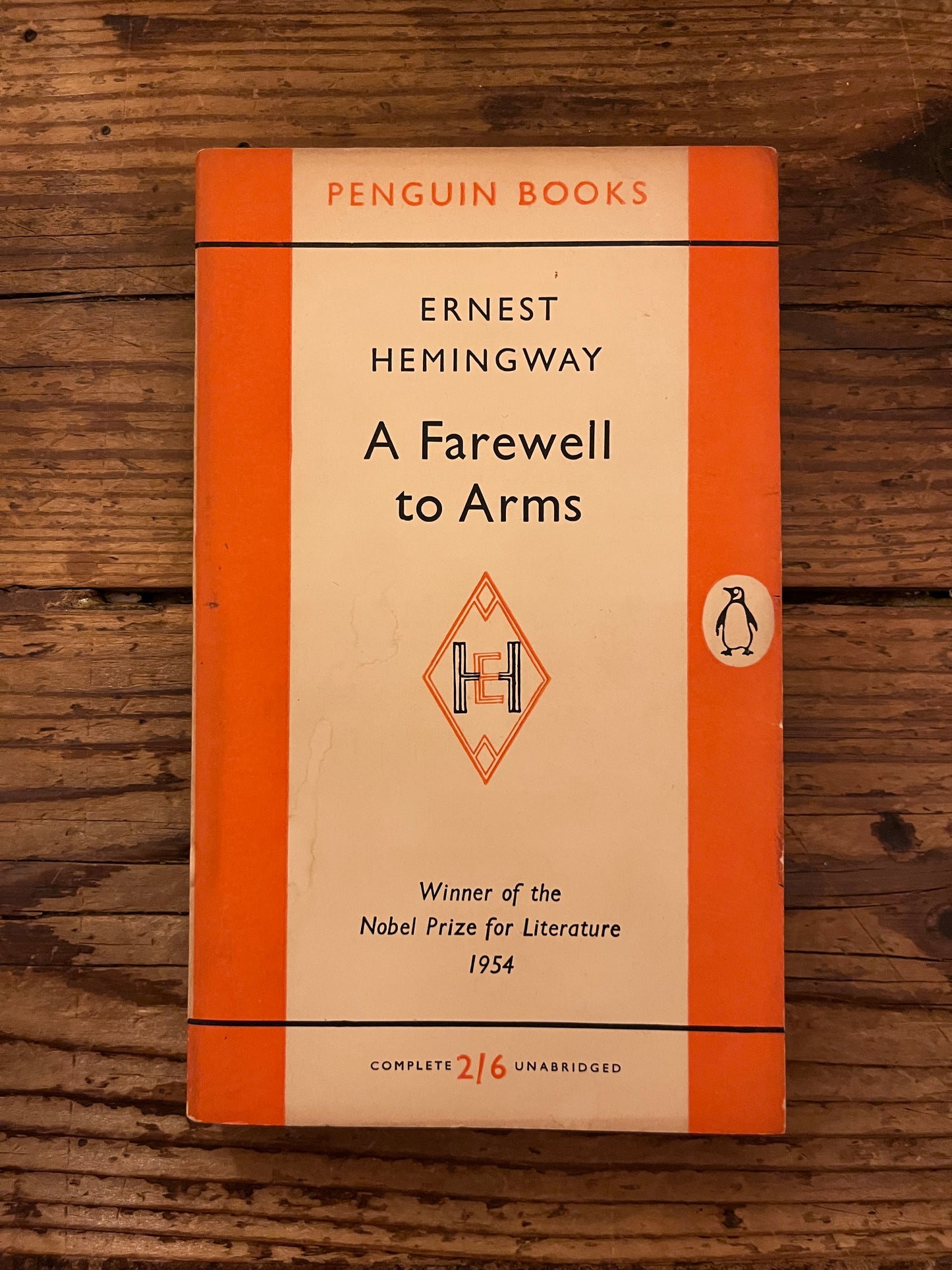cover of the book a "farewell to arms" on a wooden background