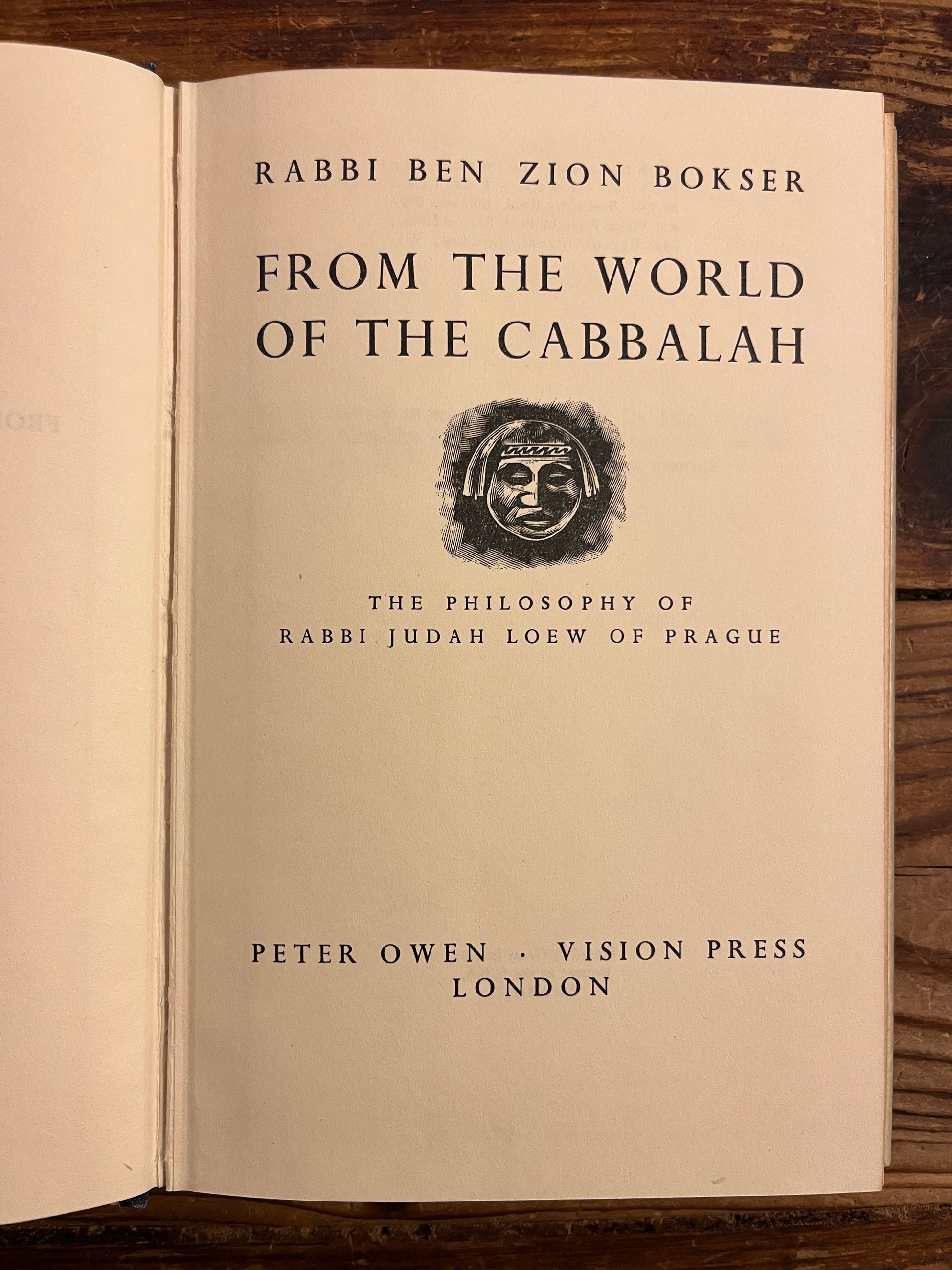 Title page of  book titled 'From the World of the Cabbalah' on a wooden surface