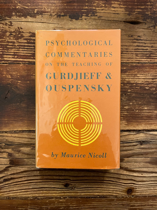 Book titled 'Psychological Commentaries on the Teaching of Gurdjieff & Ouspensky volume 5' by Maurice Nicoll on a wooden surface.