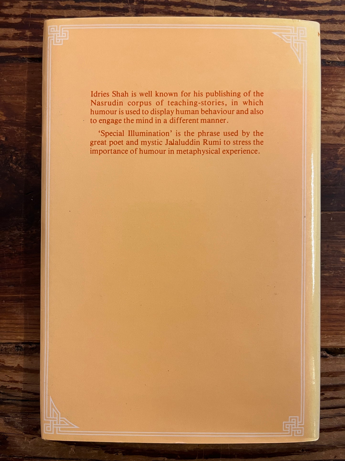 back cover of book titled 'Special Illumination' by Idries Shah on a wooden surface