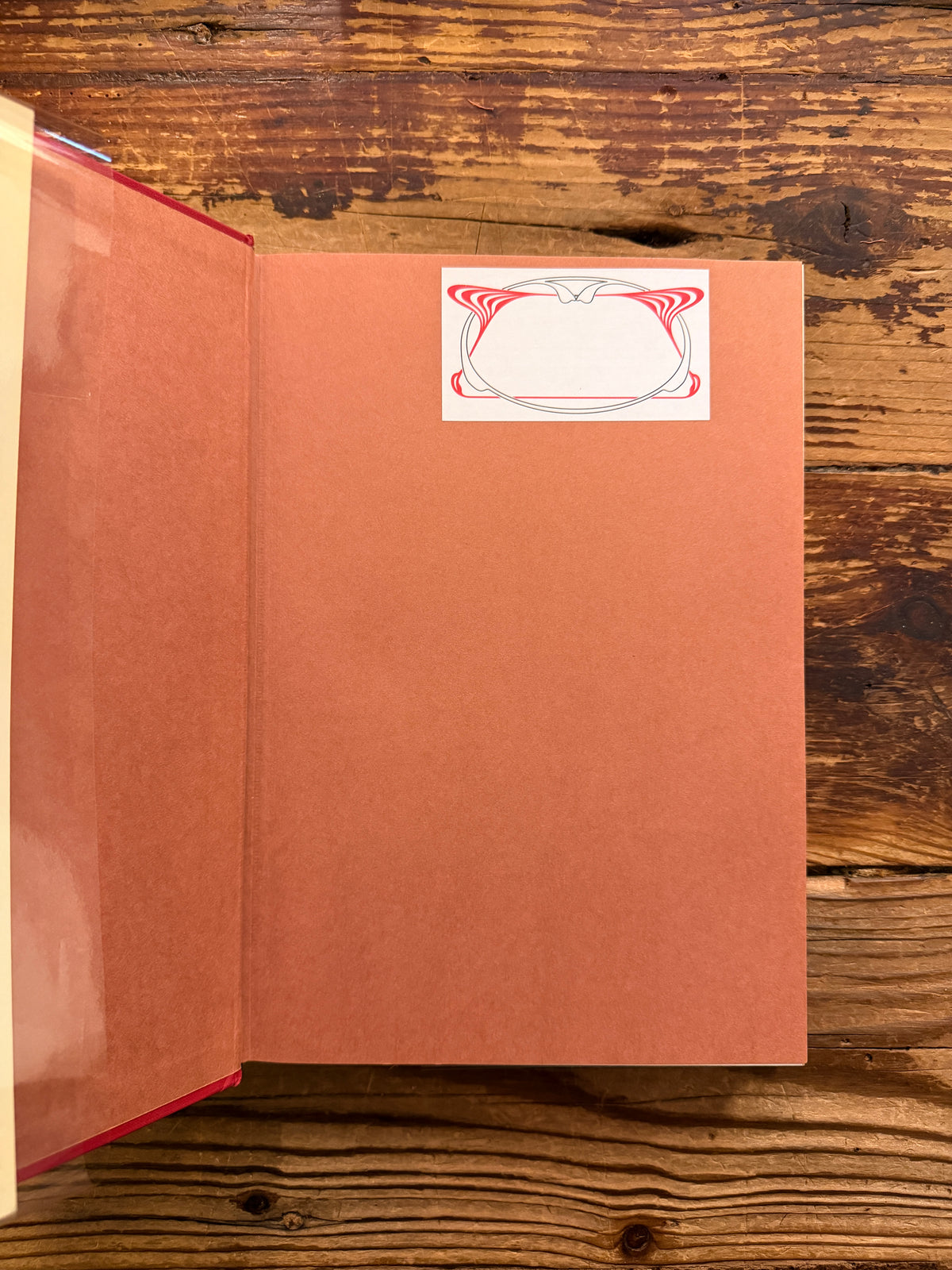 First page with name sticker of book with the title 'Dark Wood to White Rose, journey and transformation in Dante’s Divine Comedy' by Helen M. Luke on a wooden surface 