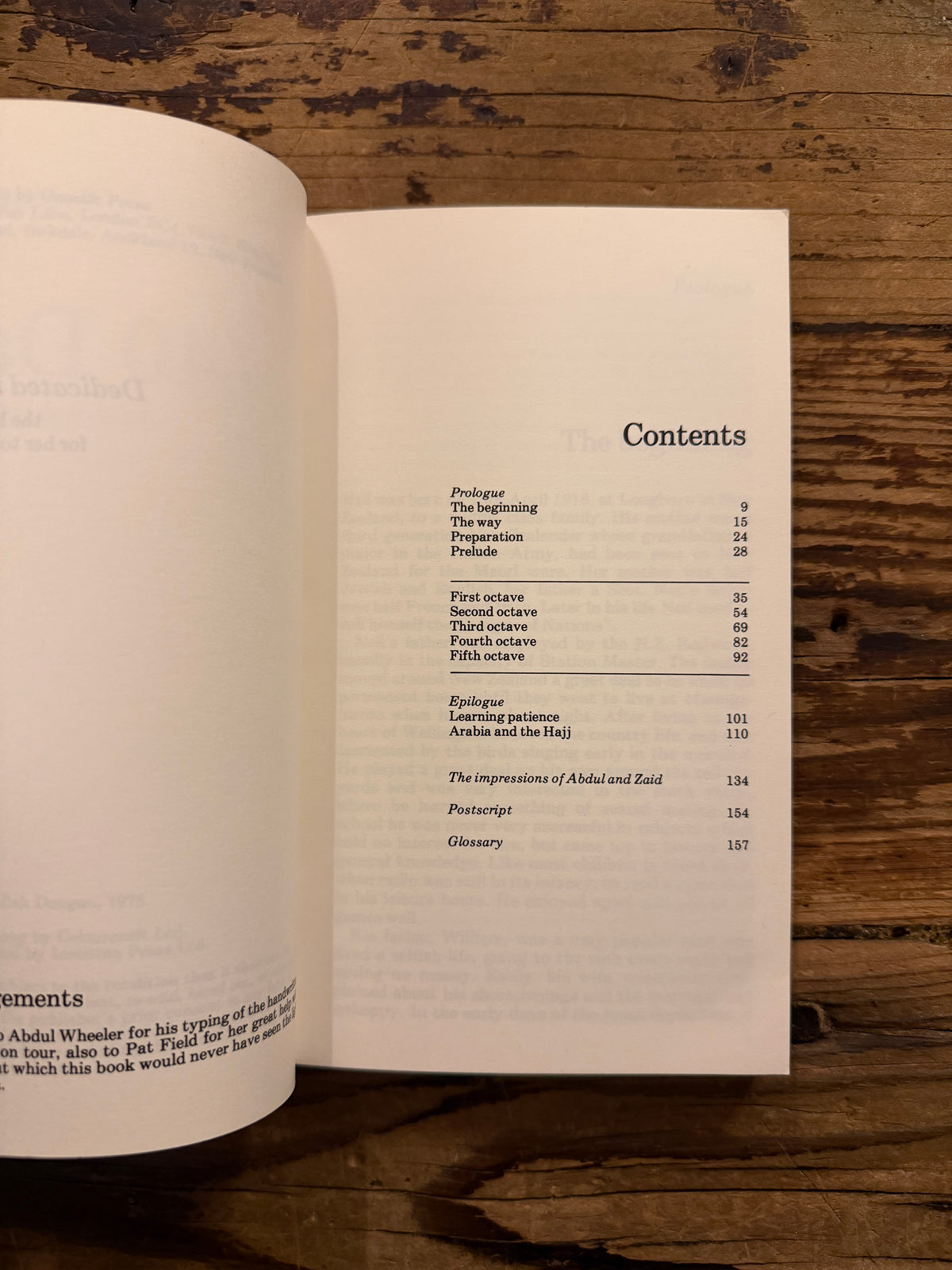 Open book with the title '40 days, an account of a discipline' by Abdullah Dougan on a wooden surface 