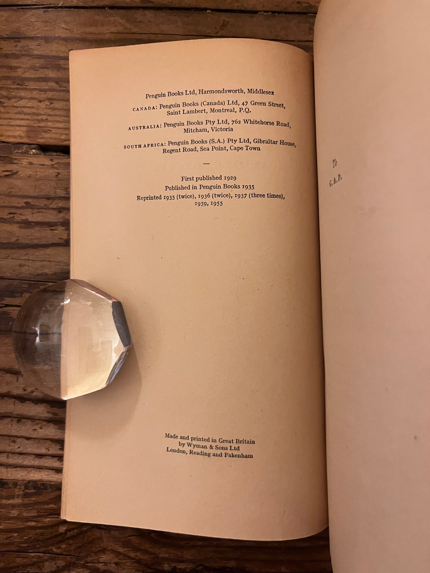 title page of the book " a farewell to arms" on a wooden background