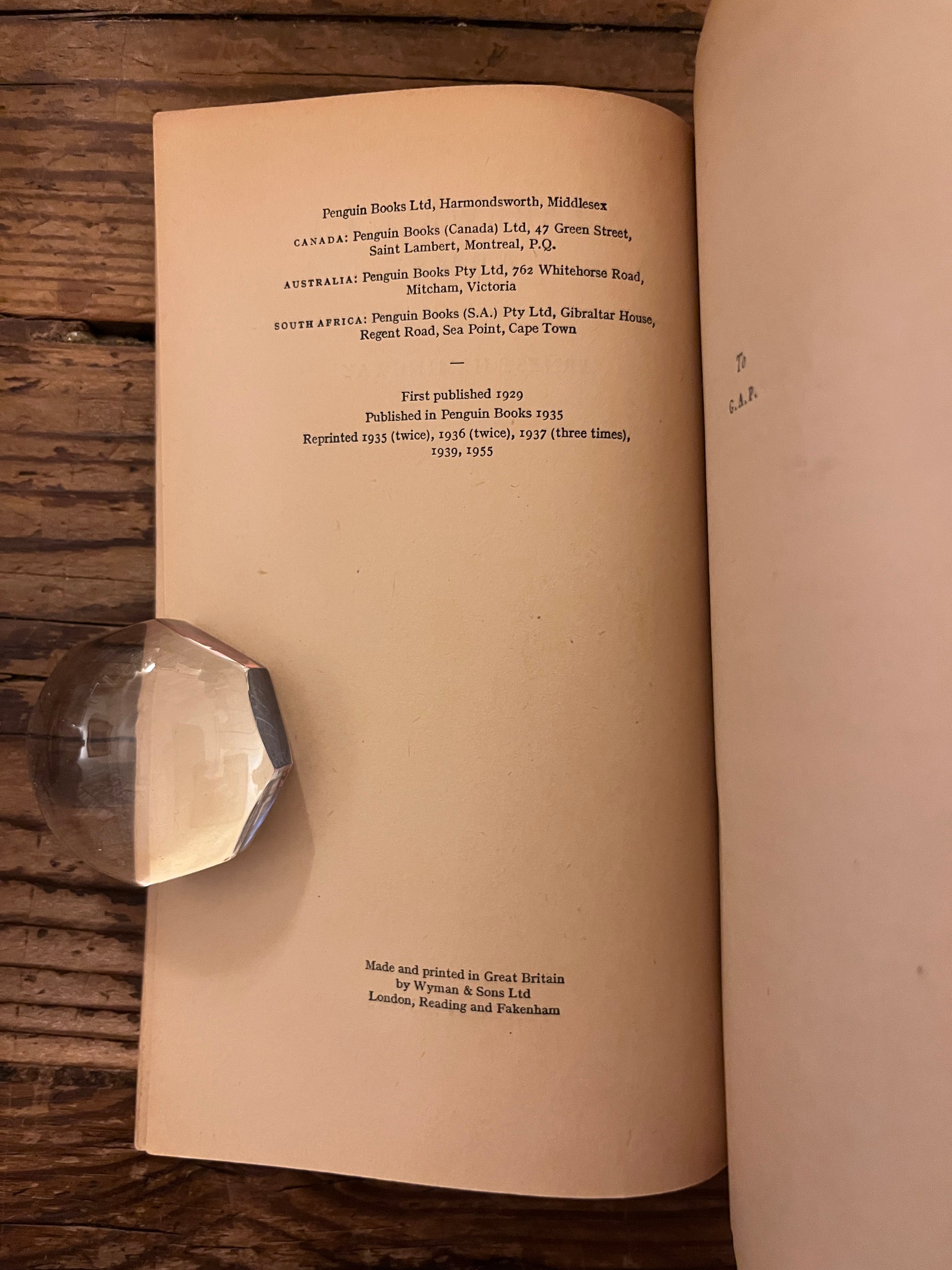 title page of the book " a farewell to arms" on a wooden background