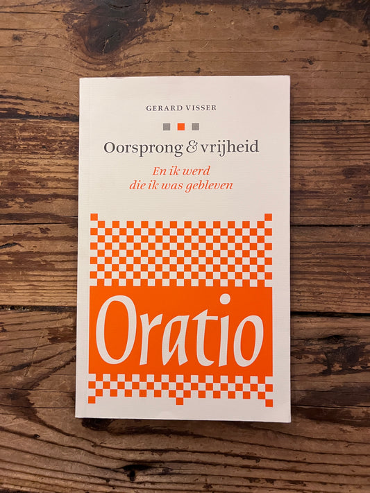 foto van de omslag van het boek "oorsprong en vrijheid" op houten achtergrond