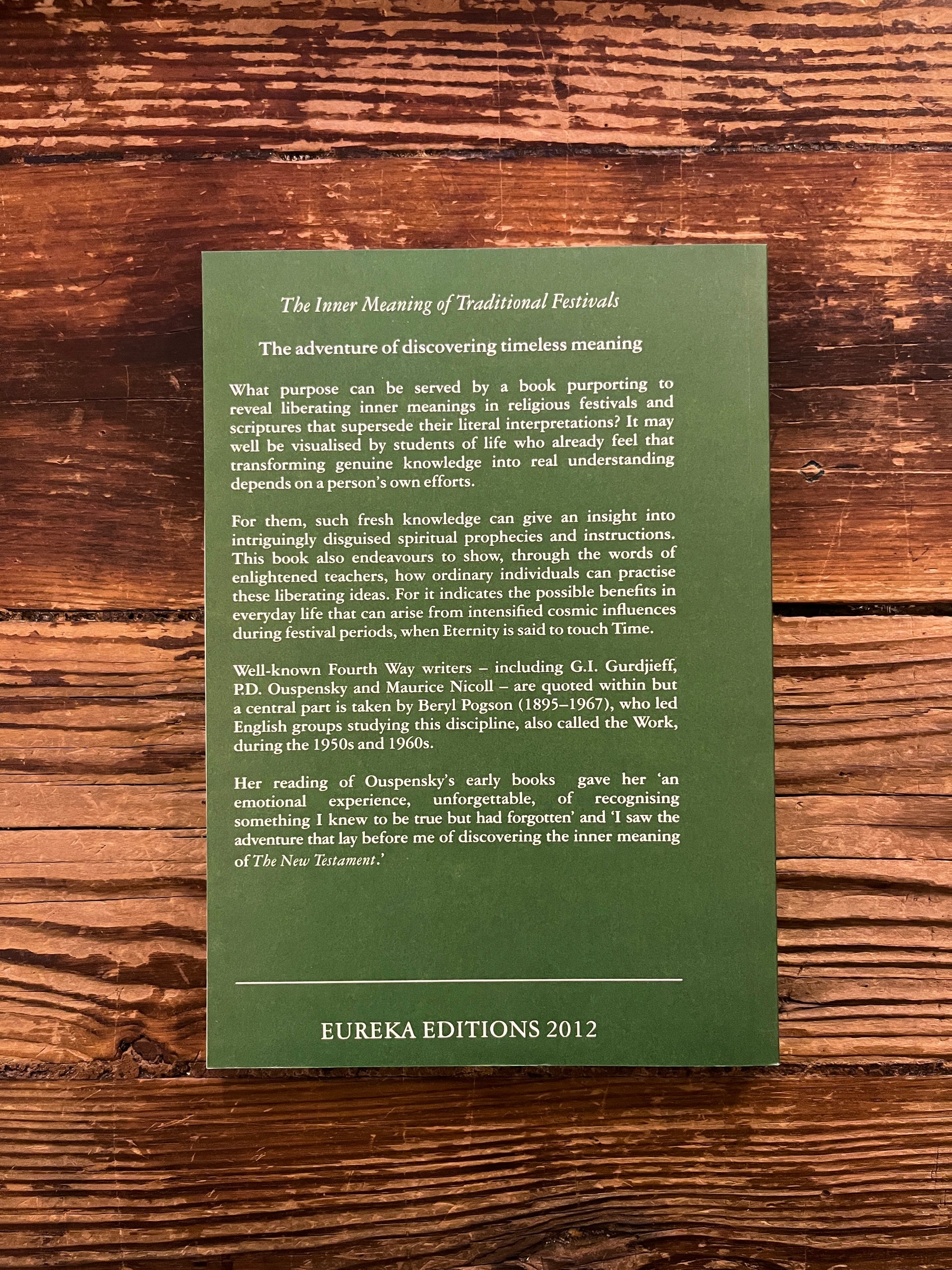 Back cover of book titled 'The Inner Meaning of Traditional Festivals' by Bob Hunter on a wooden surface