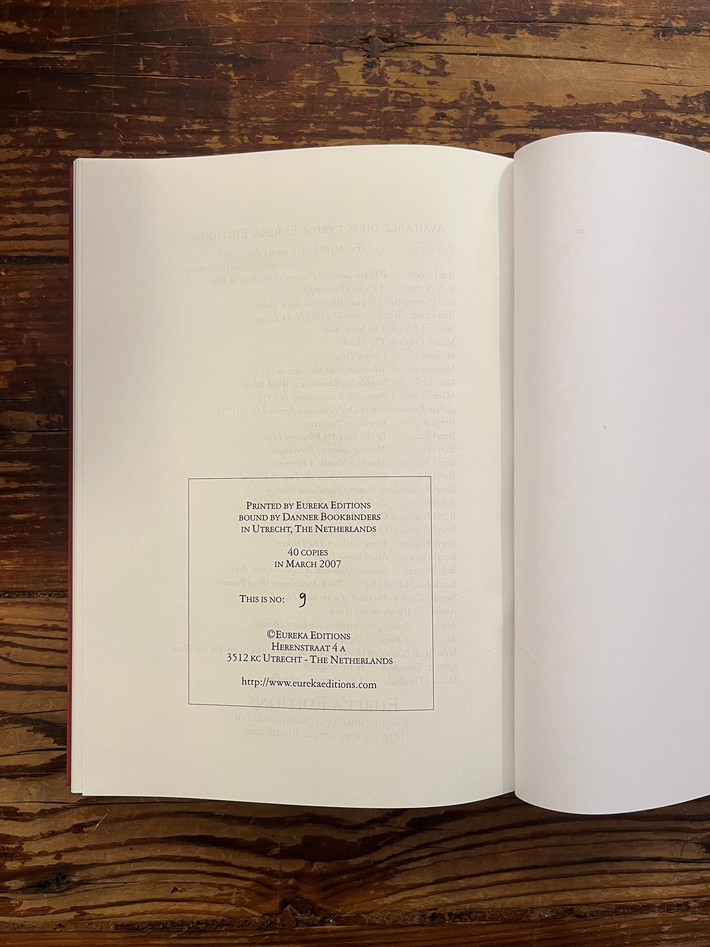 Las page with hand written number of book titled 'Gurdjieff, His work, on myself, with others, for the work' by Irmis B. Popoff on a wooden surface