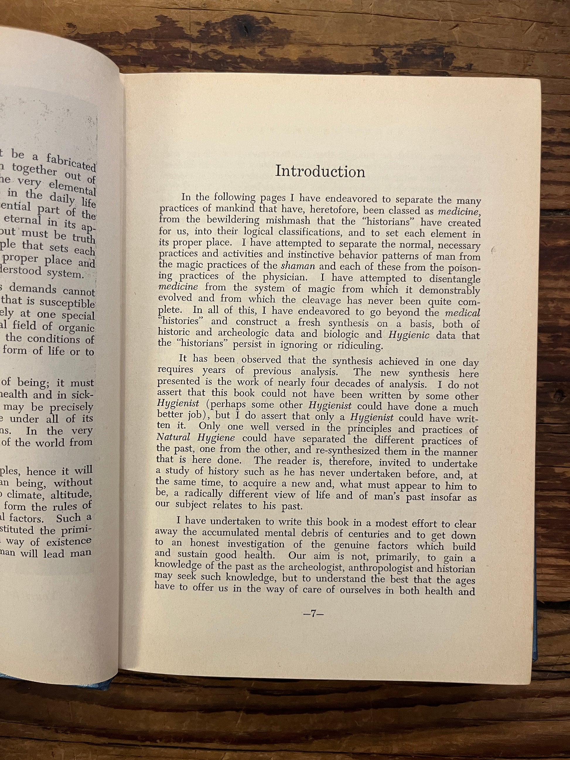 Open book titled 'Rubies in the Sand' by Herbert M. Shelton on a wooden surface