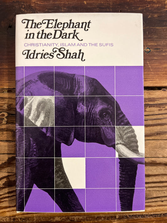 Book cover of 'The Elephant in the Dark' by Adries Shah on a wooden surface