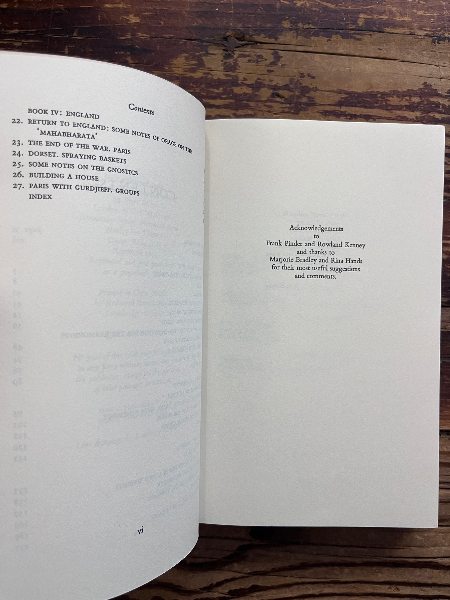 Open book titled 'Further Teachings of Gurdjieff' by C.S. Nott with an olive green cover, placed on a rustic dark wood background.