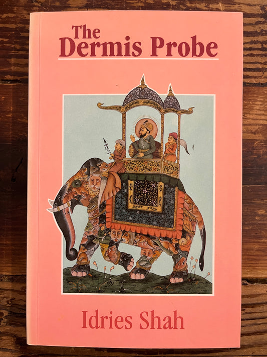 Book cover of 'The Dernis Probe' by Idries Shah on a wooden surface