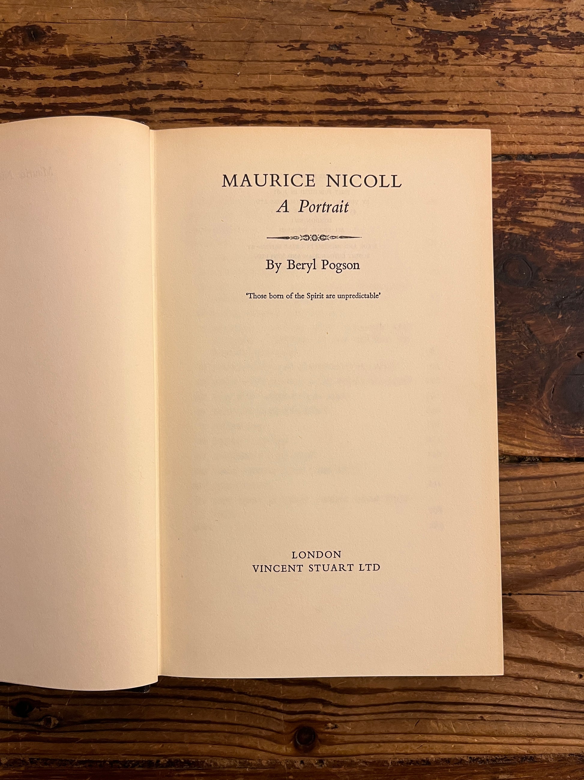 Title page of book titled 'Maurcie Nicoll a portrait' by Beryl Pogson on a wooden surface