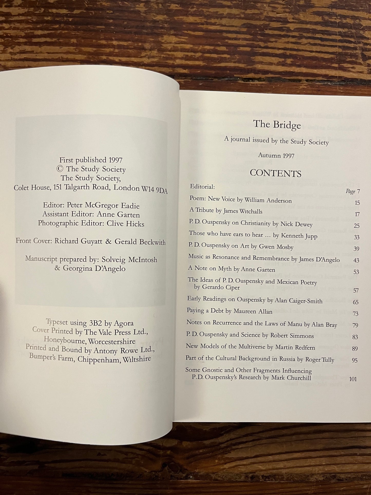 Open book titled 'The Bridge n.12 P.D. Ouspensky  commemorative issue' on a wooden surface