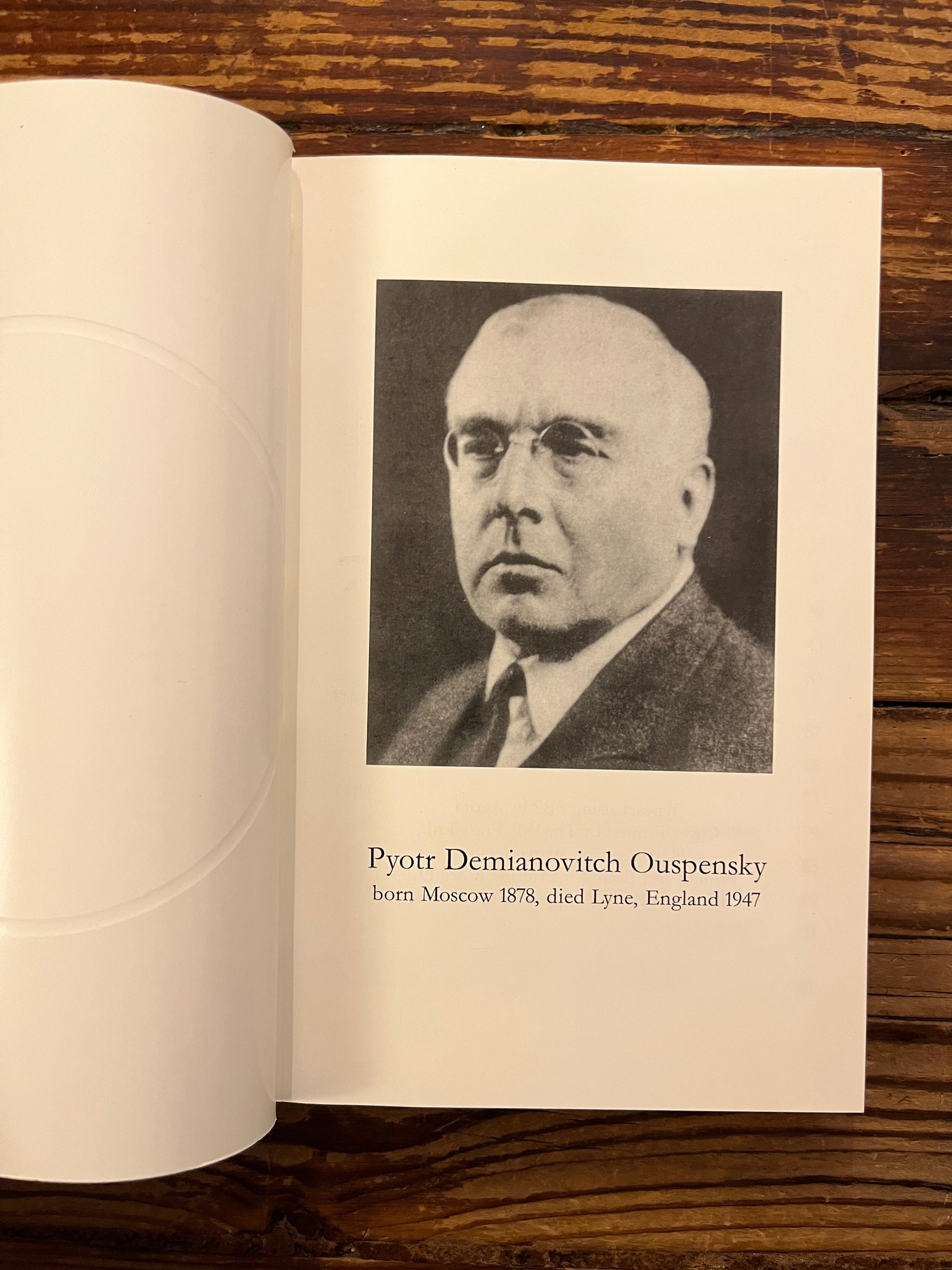 Open book titled 'The Bridge n.12 P.D. Ouspensky  commemorative issue' on a wooden surface