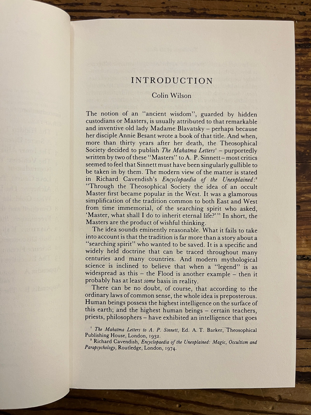 First page of book with the title 'The People of the Secret' by Ernest Scott lying on a wooden surface