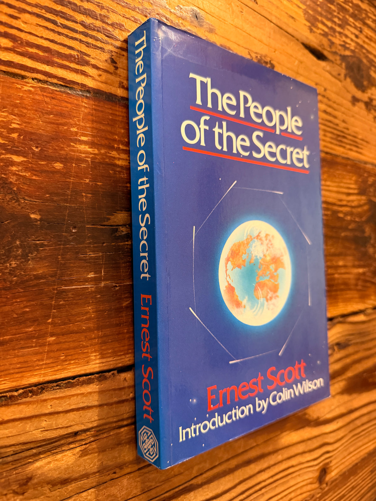 front cover and spine of book with the title 'The People of the Secret' by Ernest Scott lying on a wooden surface