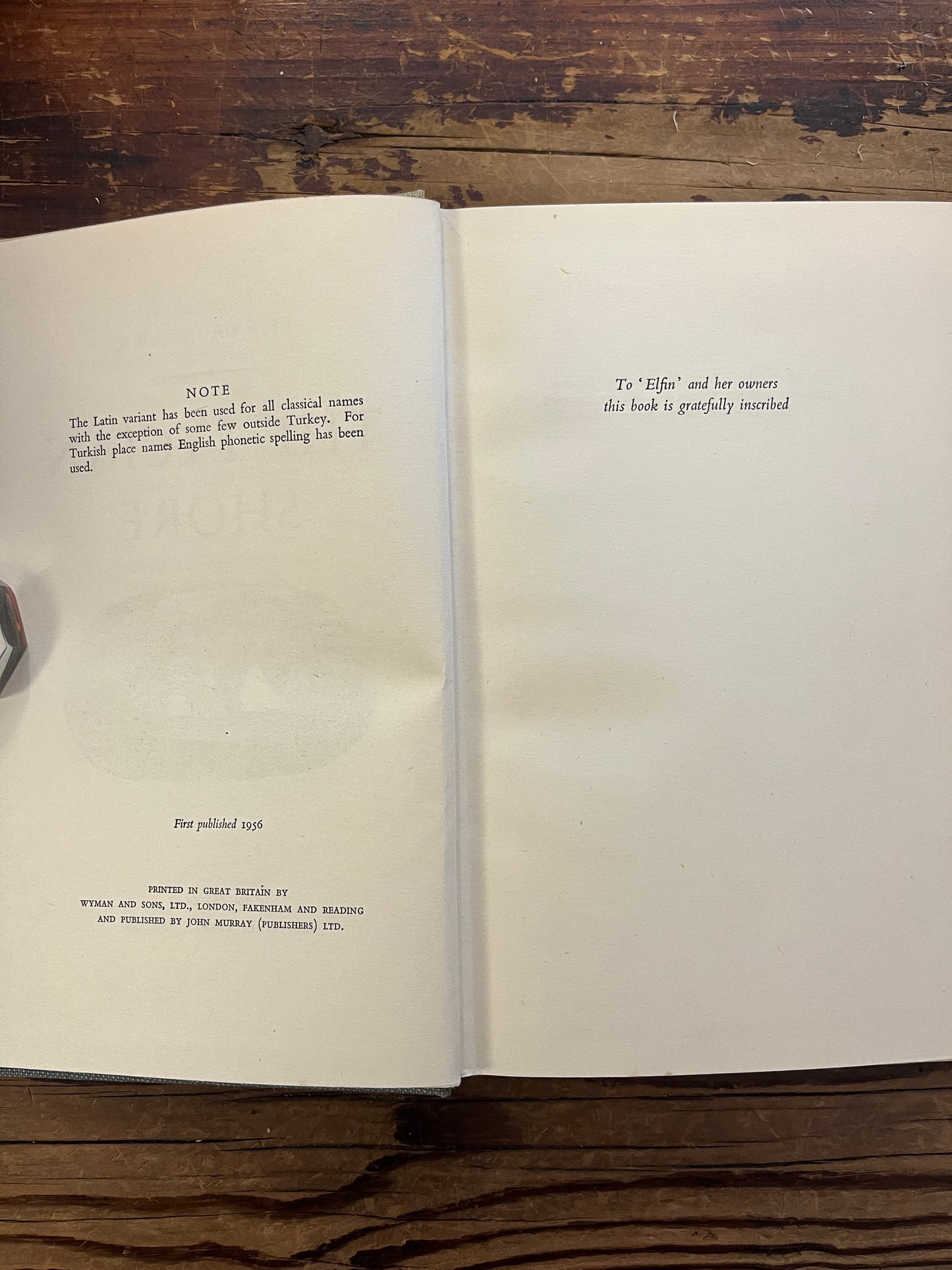 Open book titled 'The Lycian Shore' by Freya Stark on a wooden surface