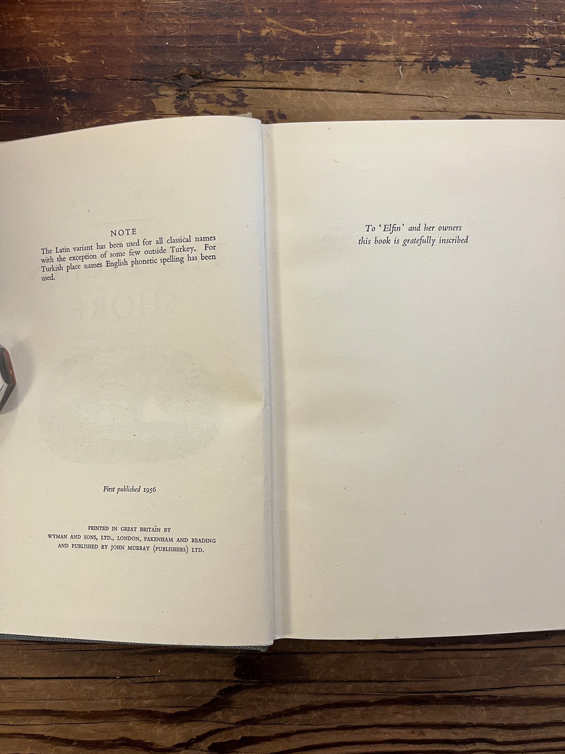 Open book titled 'The Lycian Shore' by Freya Stark on a wooden surface