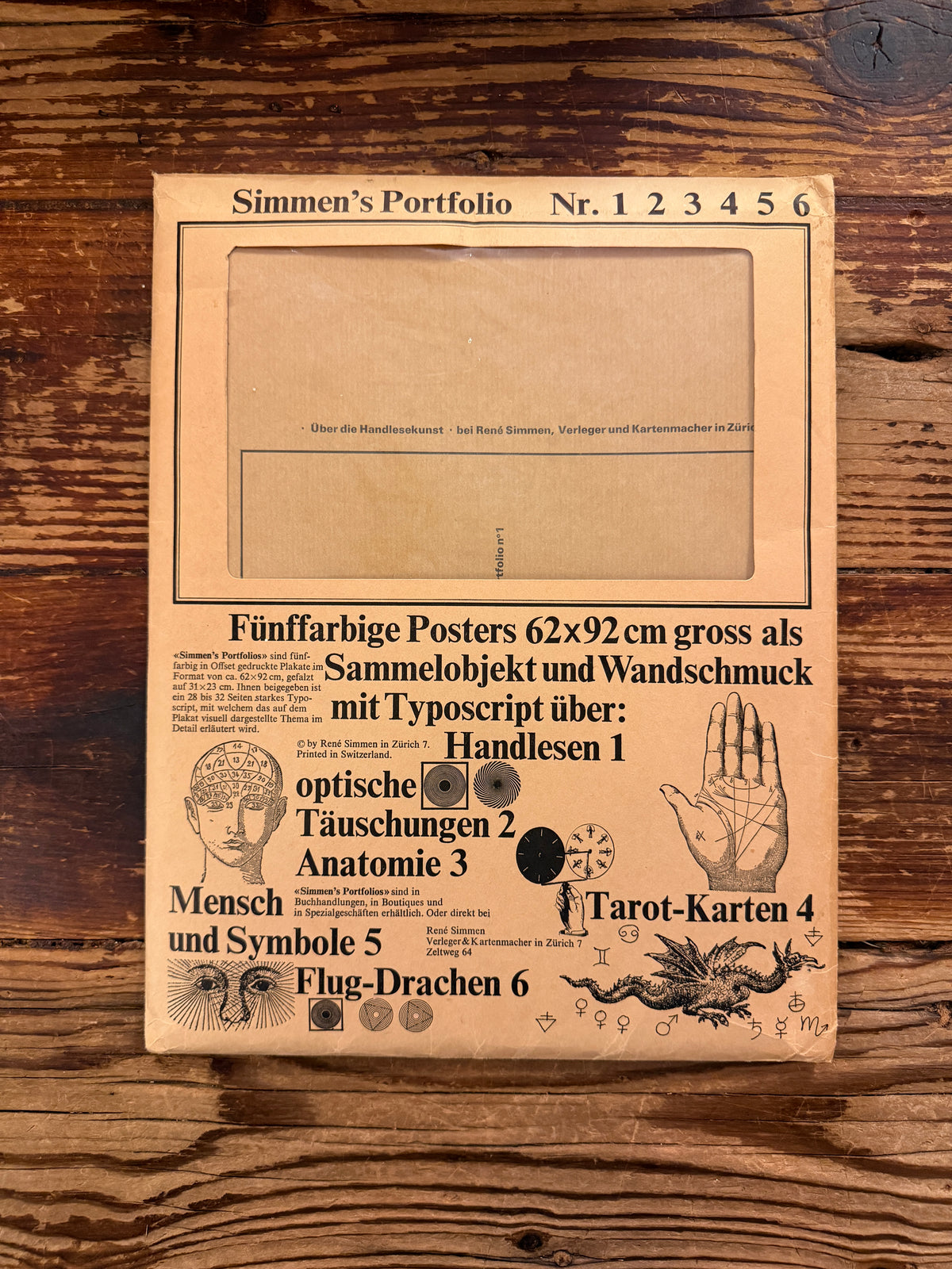 Front cover of 'Simmen's Portfolio No. 1: Die glückliche Hand' on a wooden background 