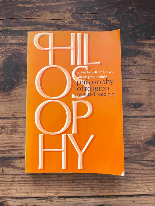 photo of the cover of the book "philosophy of religion" on a wooden background