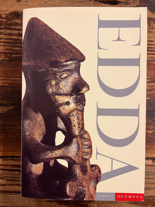 Book titled 'Edda' with a front cover featuring a decorative object on a wooden surface