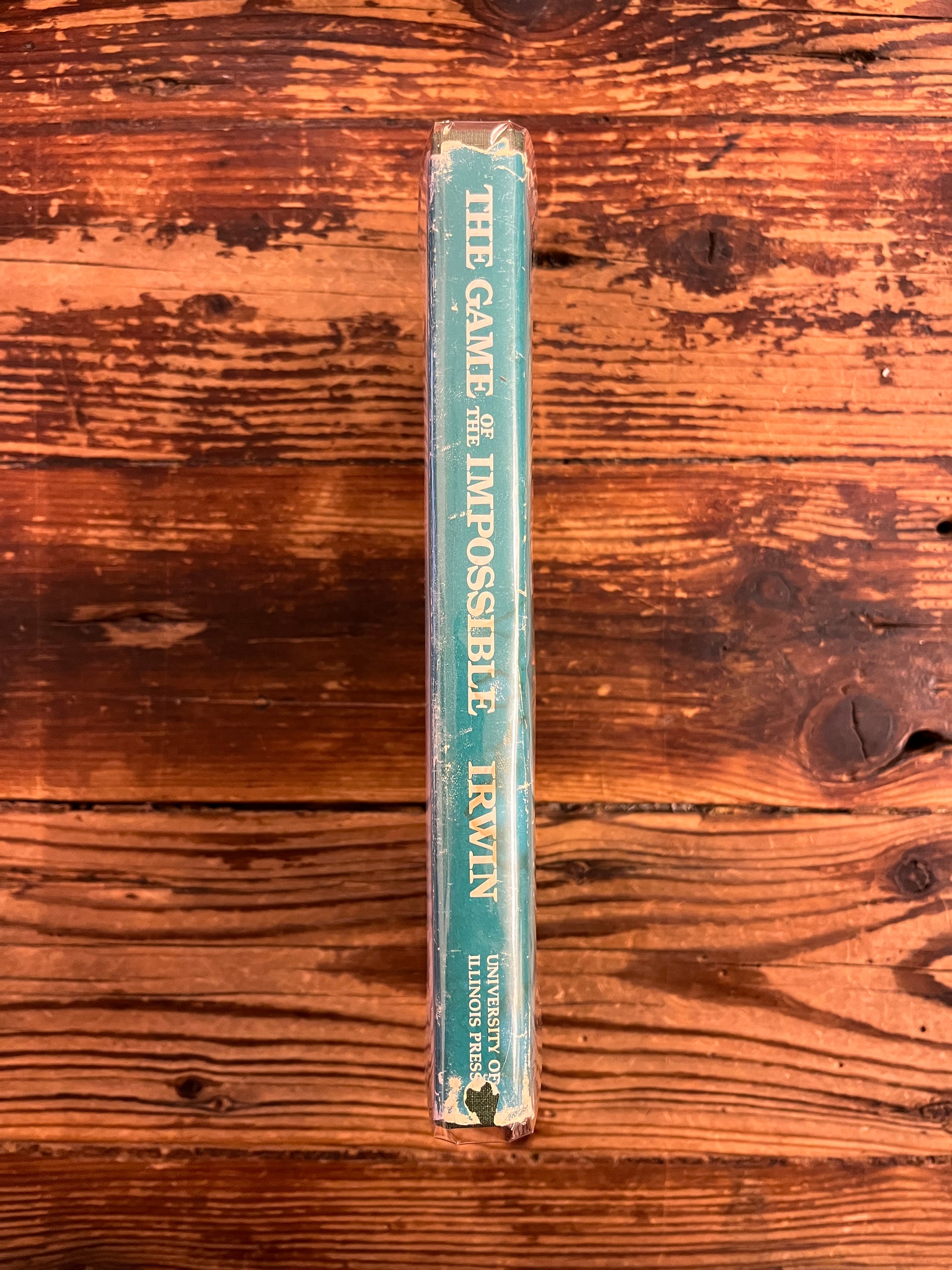 spine of book titled 'The Game of the Impossible: A Rhetoric of Fantasy' by W.R. Irwin on a wooden surface