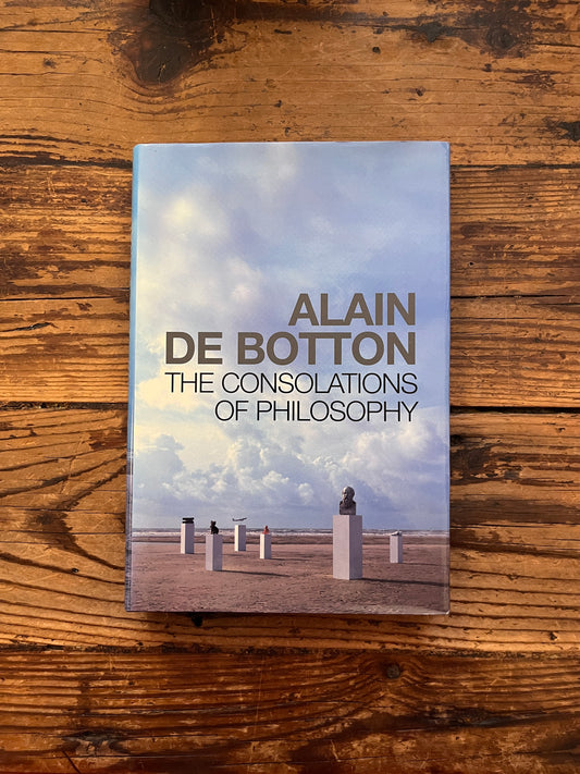 photo of the cover of the book "The consolation of philosophy" on a wooden backgrounds