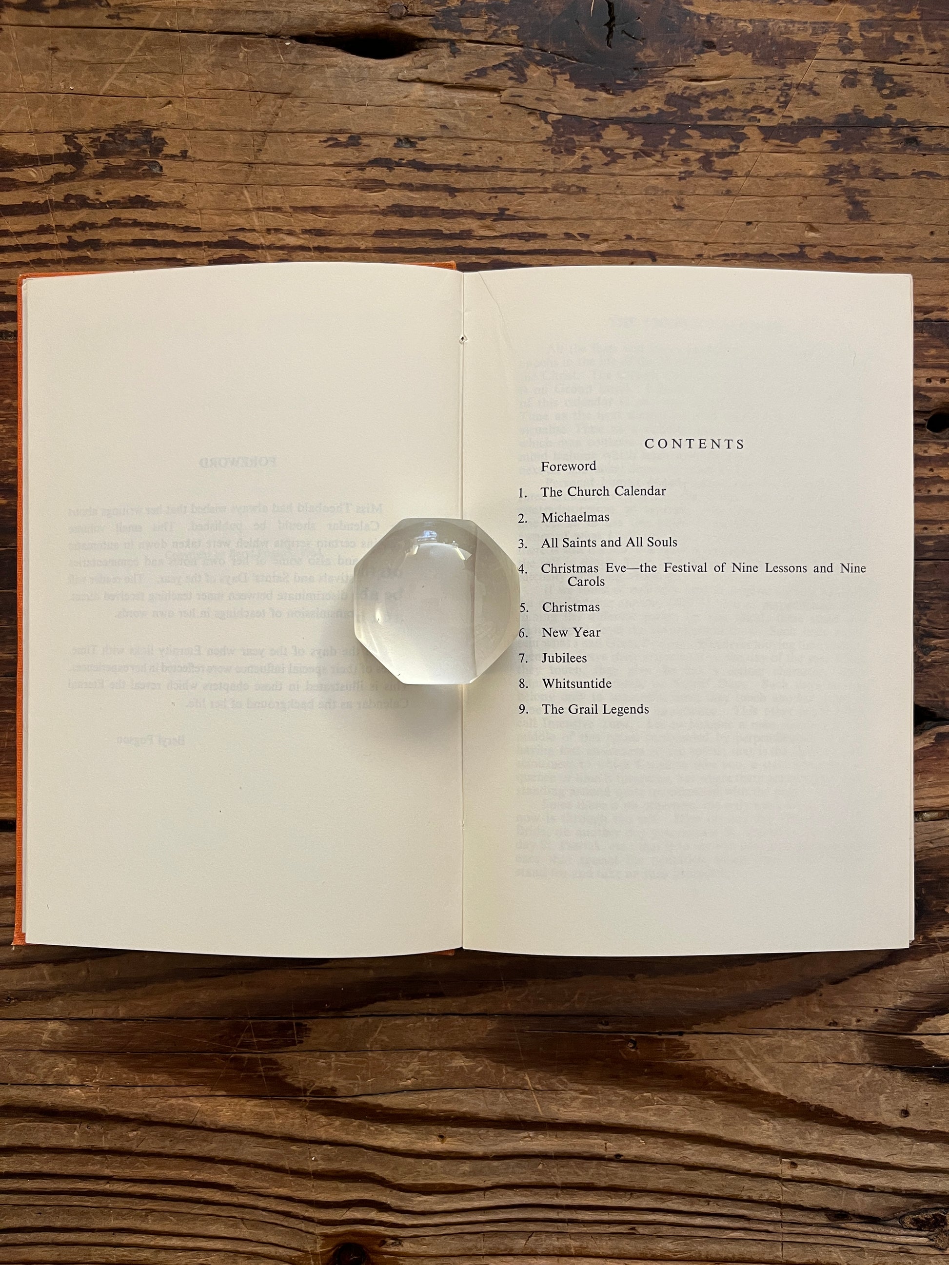 Open book with the tile 'the eternal calendar' by Minnie Theobald on a wooden surface