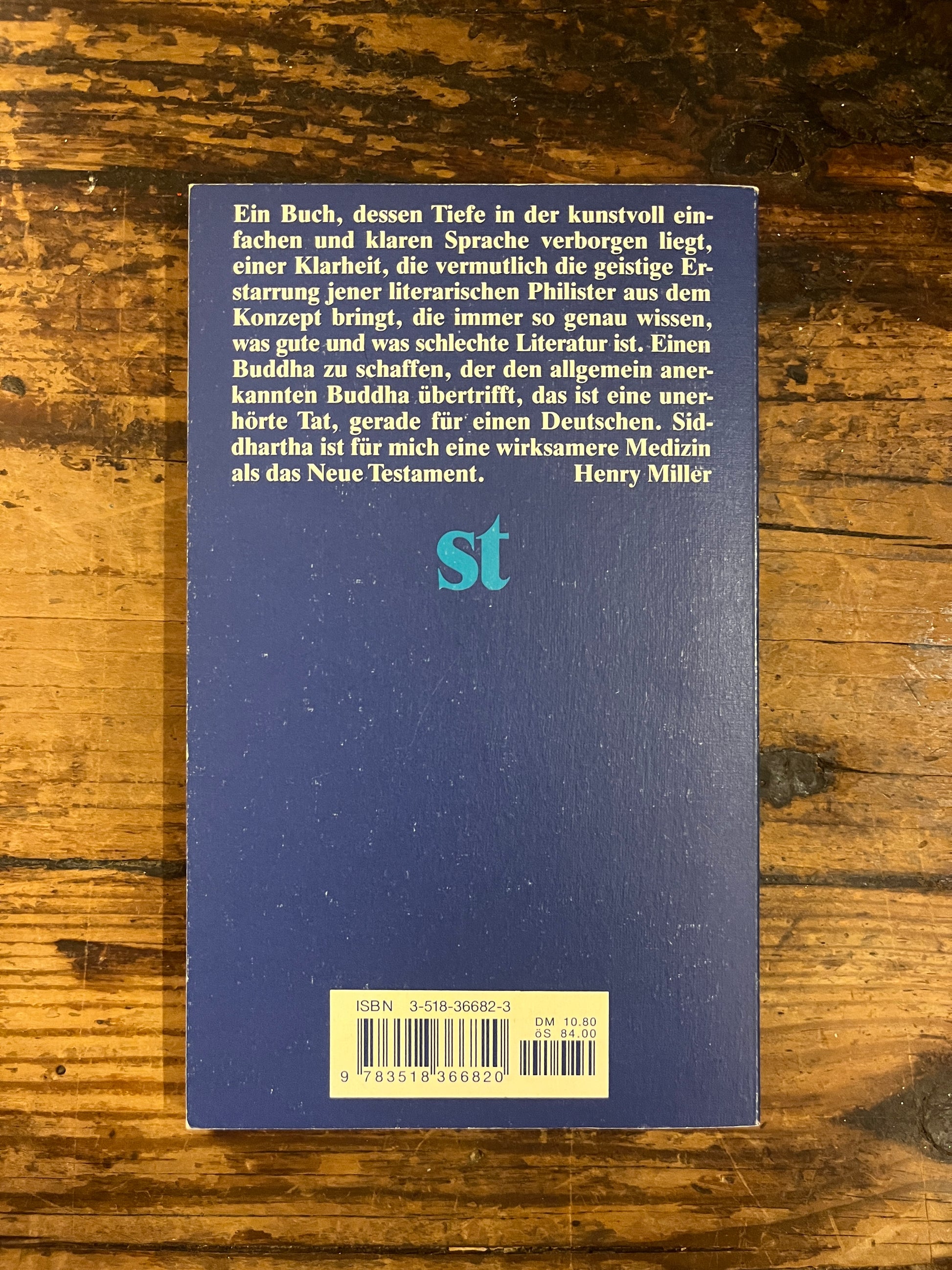 photo of the backcover of the book "Siddharta" ona wooden background