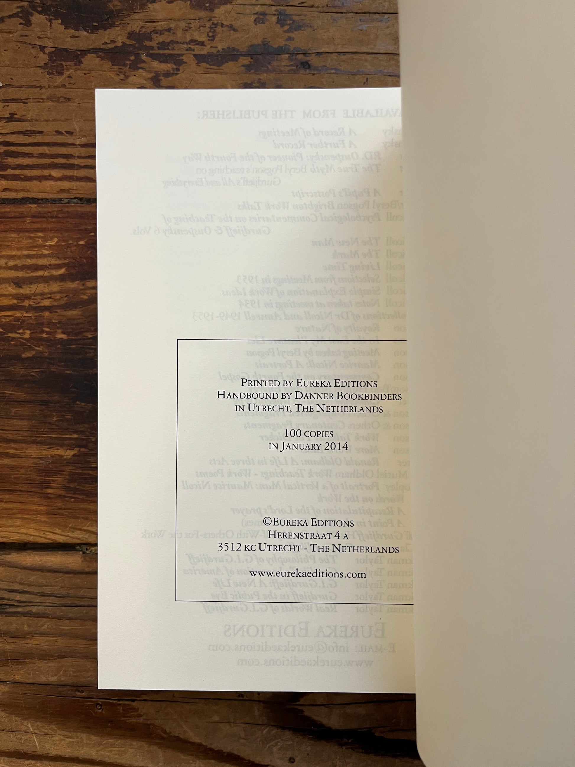 Book titled 'The Oragean Version' by C. Daly King on a wooden surface