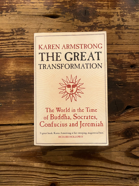 Front cover of the book with the title 'The great transformation' by Karen Armstrong on a wooden surface