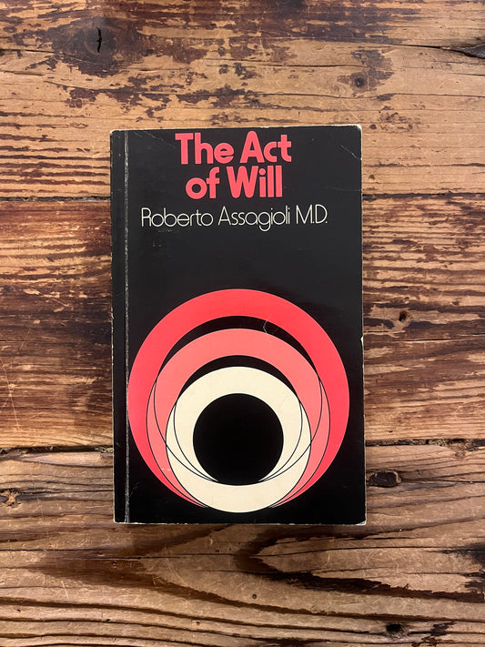 Book titled 'The Act of Will' by Roberto Assagioli on a wooden surface
