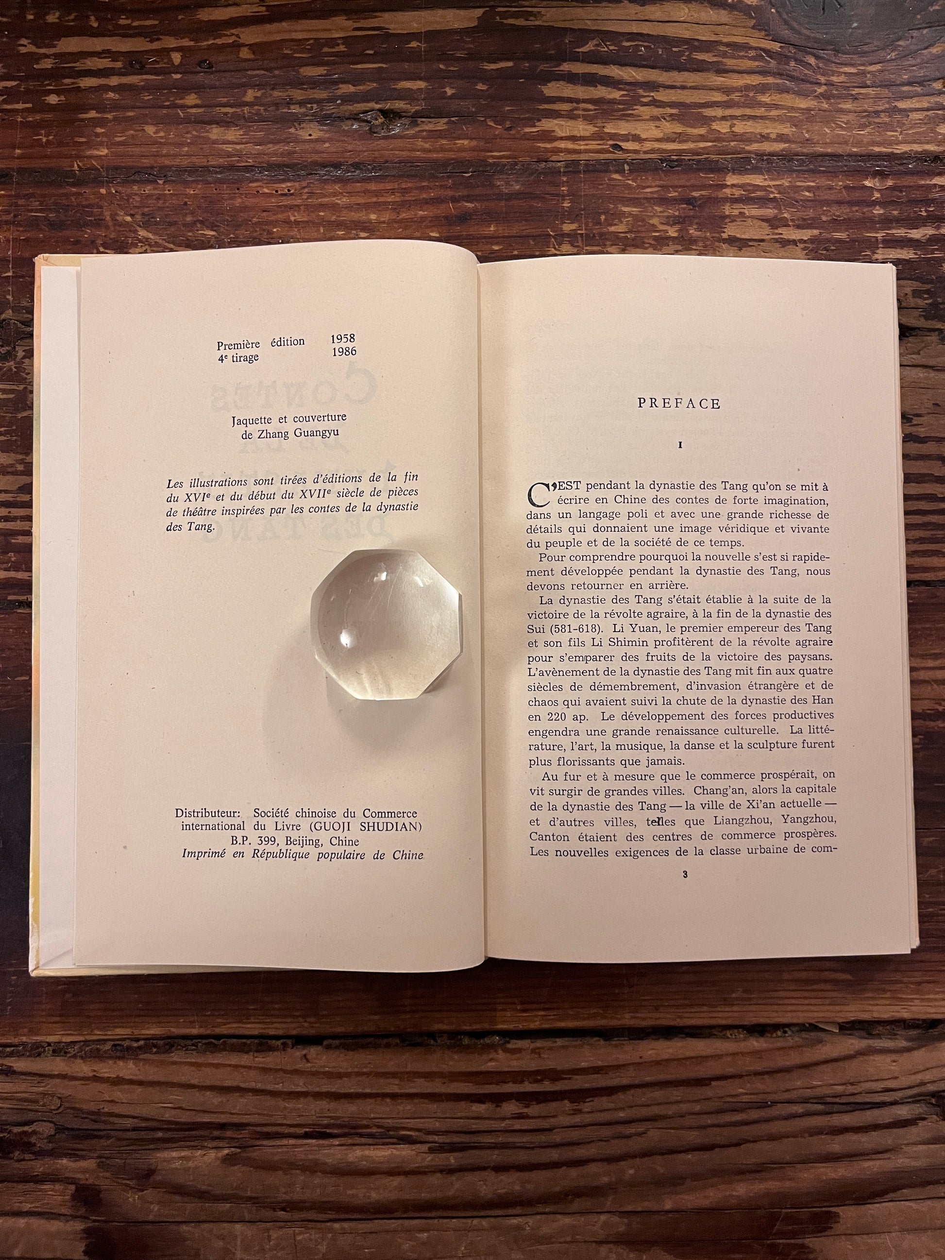 photo de la demie page de titre du livre "les contes de la dynastie des tang"sur fond de bois