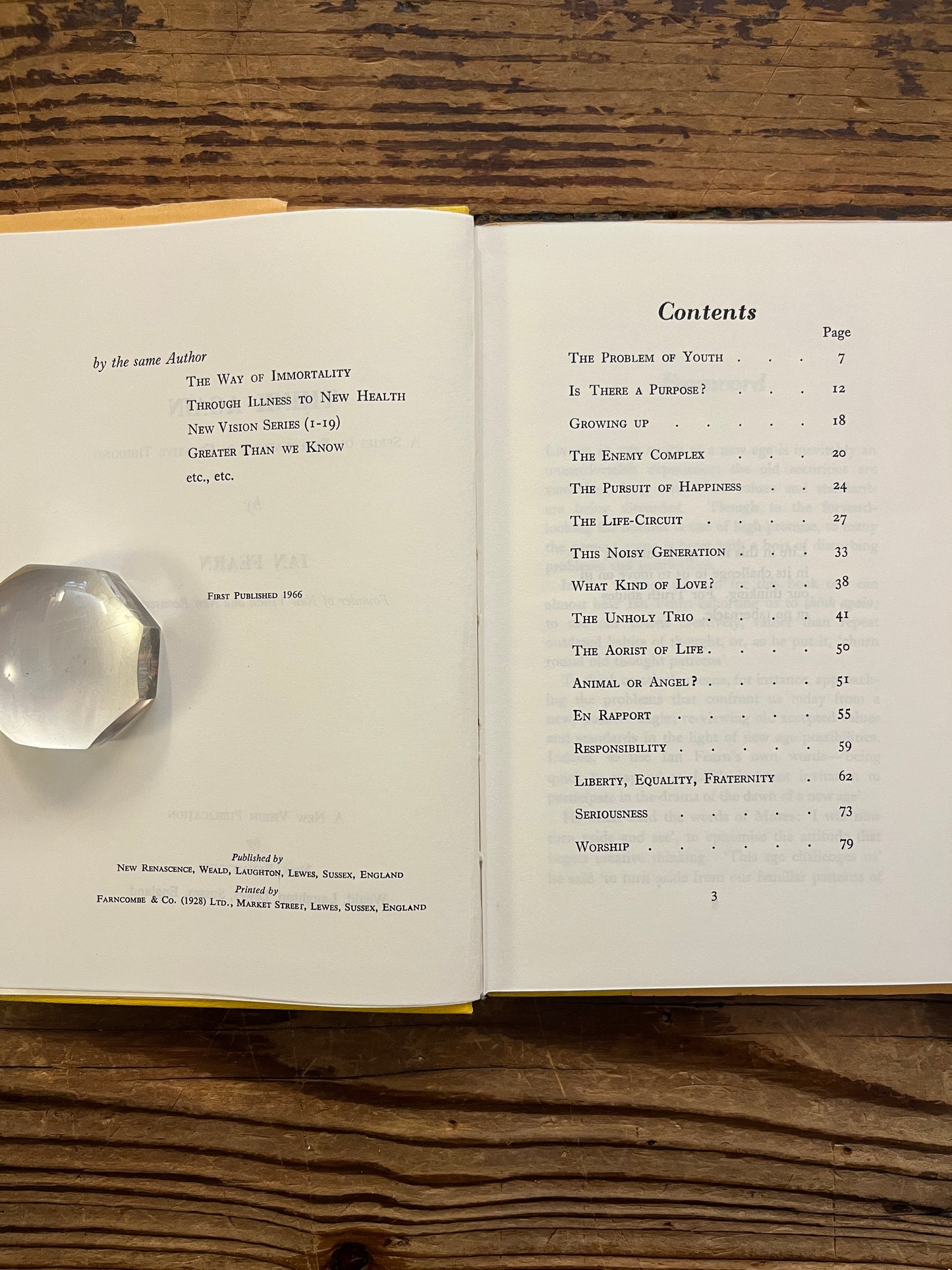 Open book with the title 'Think Again' by Ian Fearn on a wooden surface