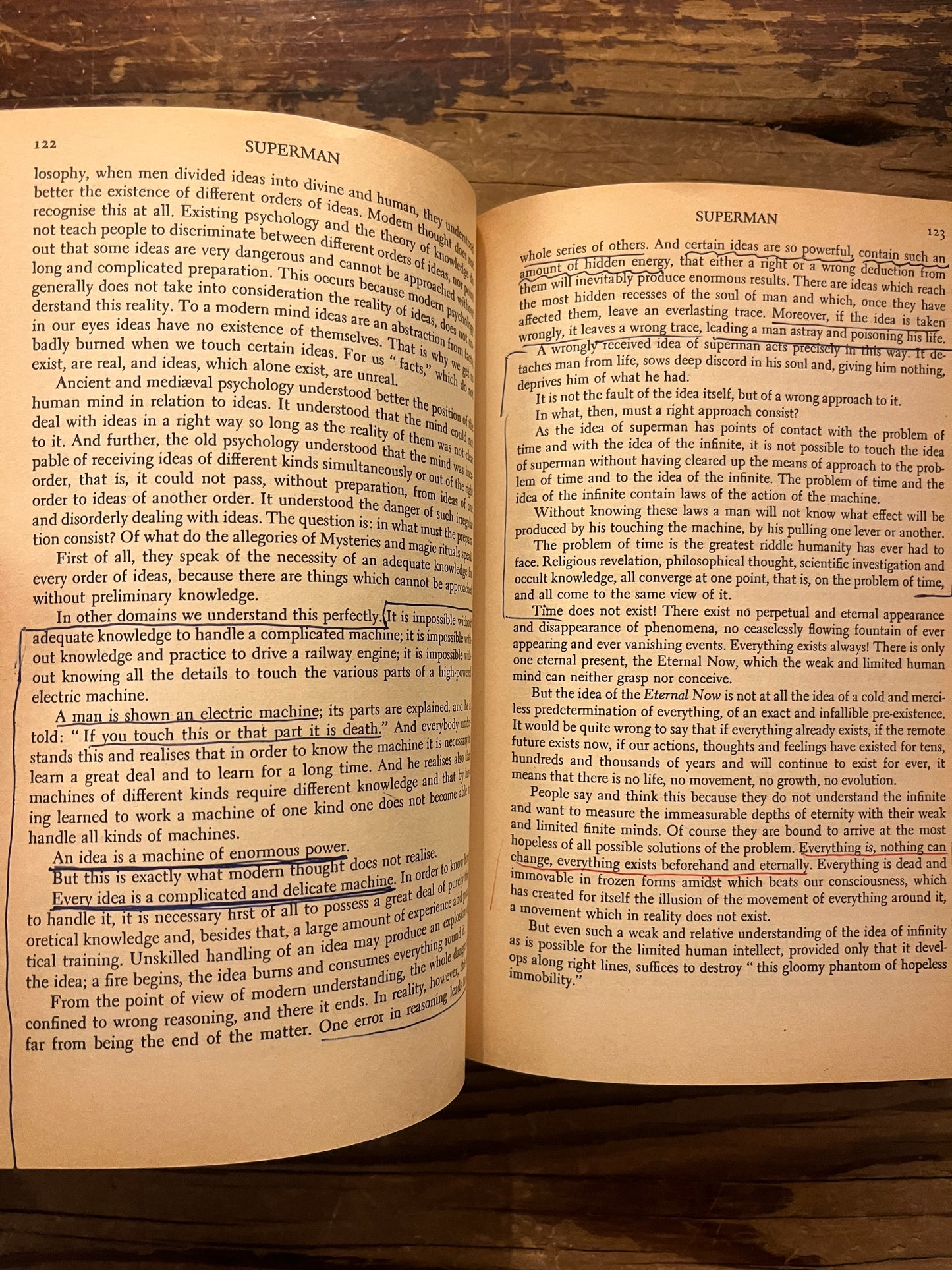 Open book titled 'A New Model of the Universe' by P.D. Ouspensky on a wooden surface