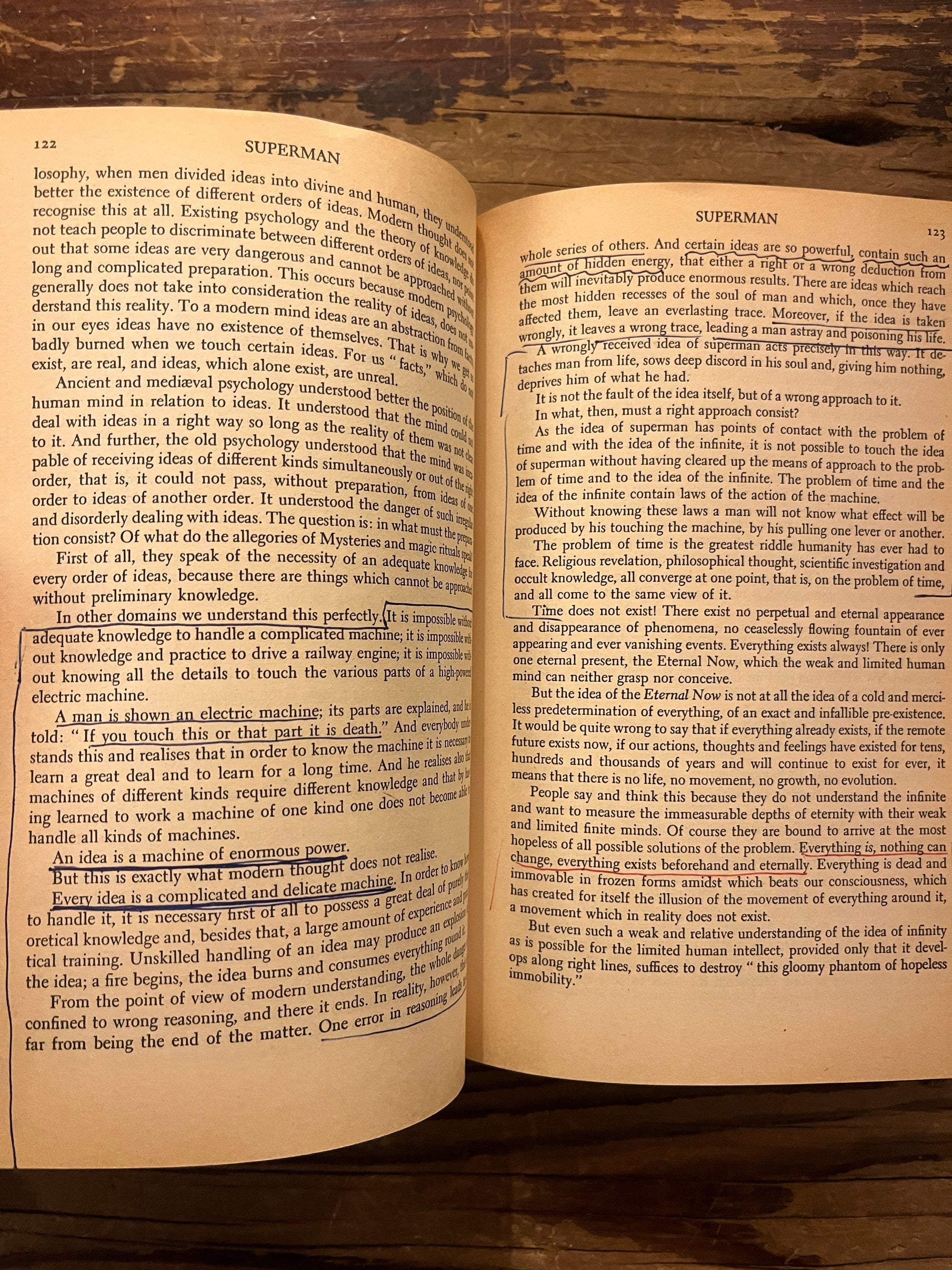 Open book titled 'A New Model of the Universe' by P.D. Ouspensky on a wooden surface