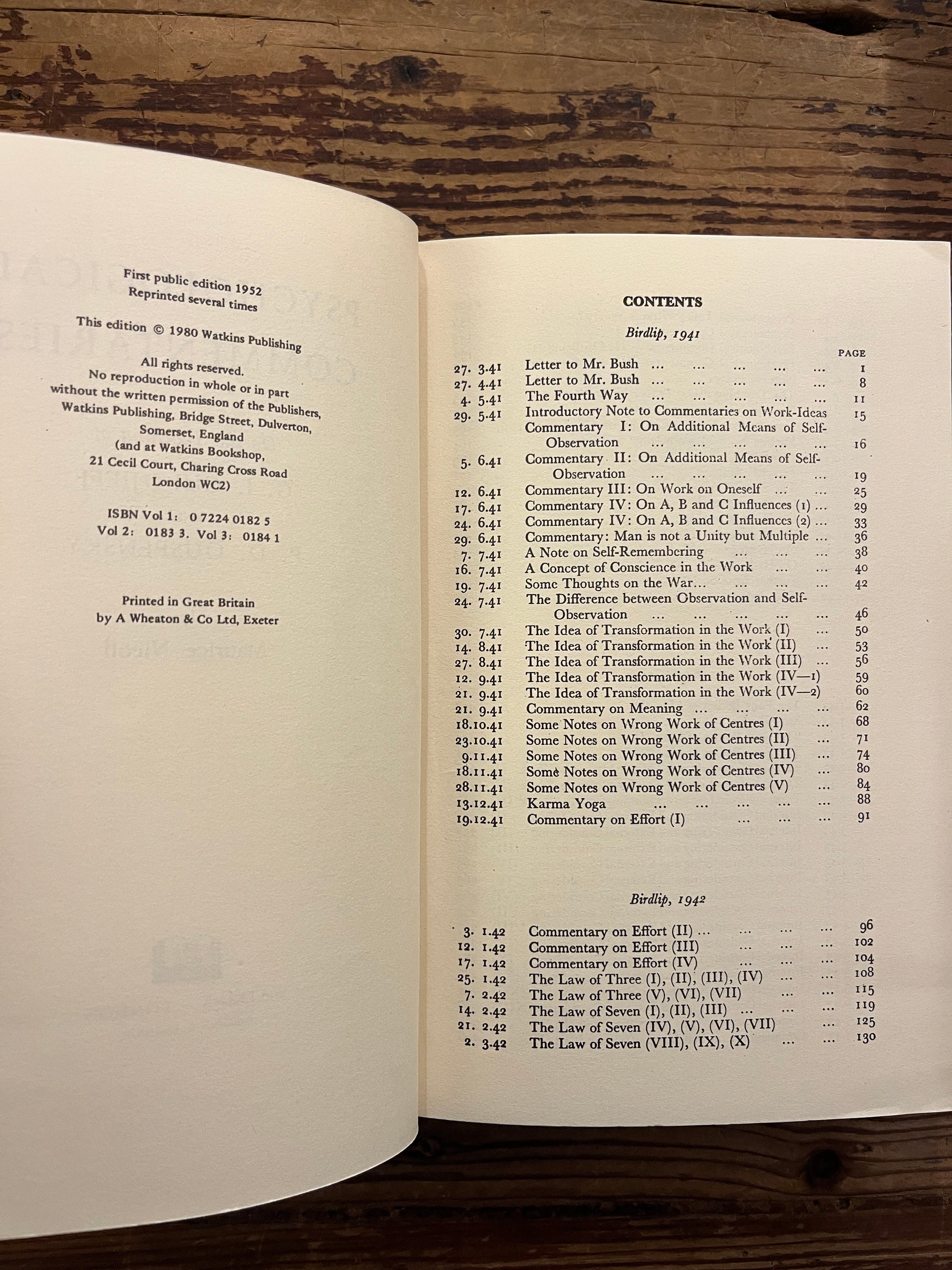 Open book titled 'Psychological Commentaries on the Teaching of Gurdjieff & Ouspensky' by Maurice Nicoll on a wooden surface
