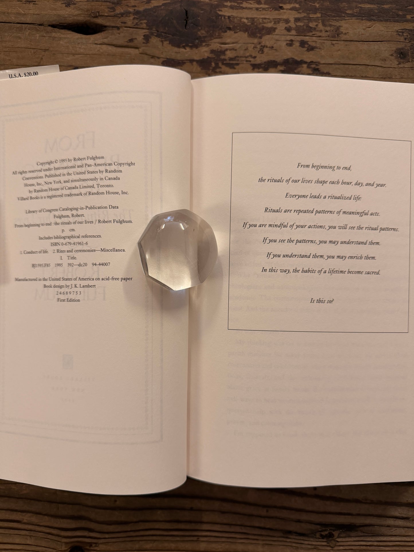 Open book titled 'From Beginning to End: The Rituals of Our Lives' by Robert Fulghum on a wooden surface