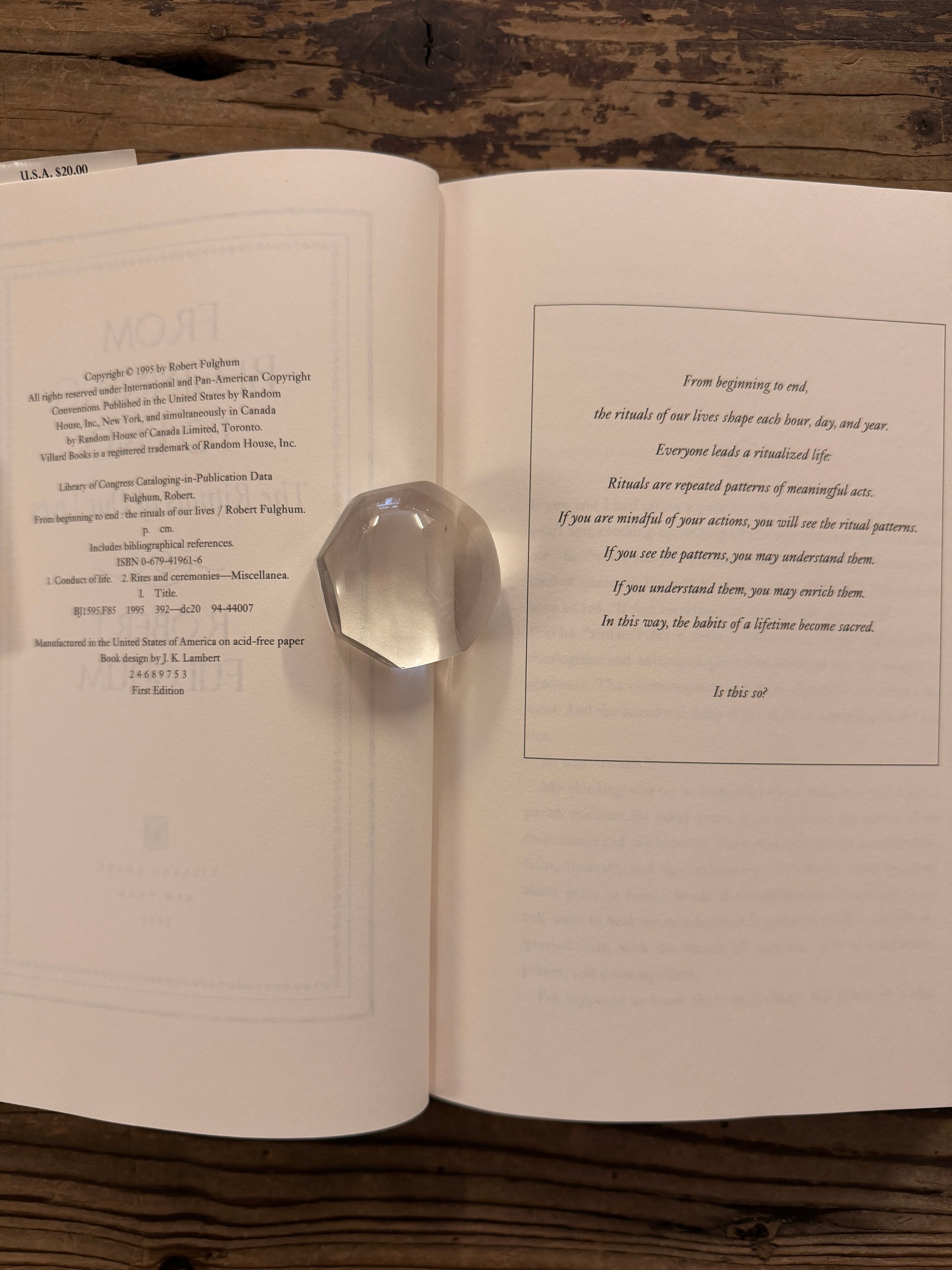 Open book titled 'From Beginning to End: The Rituals of Our Lives' by Robert Fulghum on a wooden surface