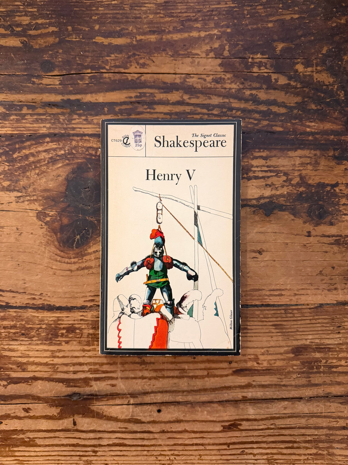 photo of the cover of the book "Henry V" on a wooden background