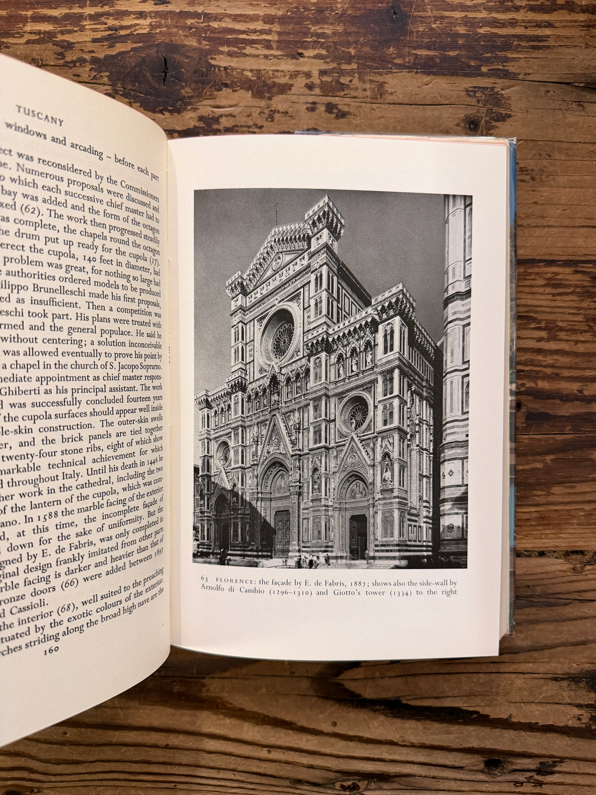 Open book with the title 'The Cathedrals of Italy' by J.W. Franklin on a wooden surface