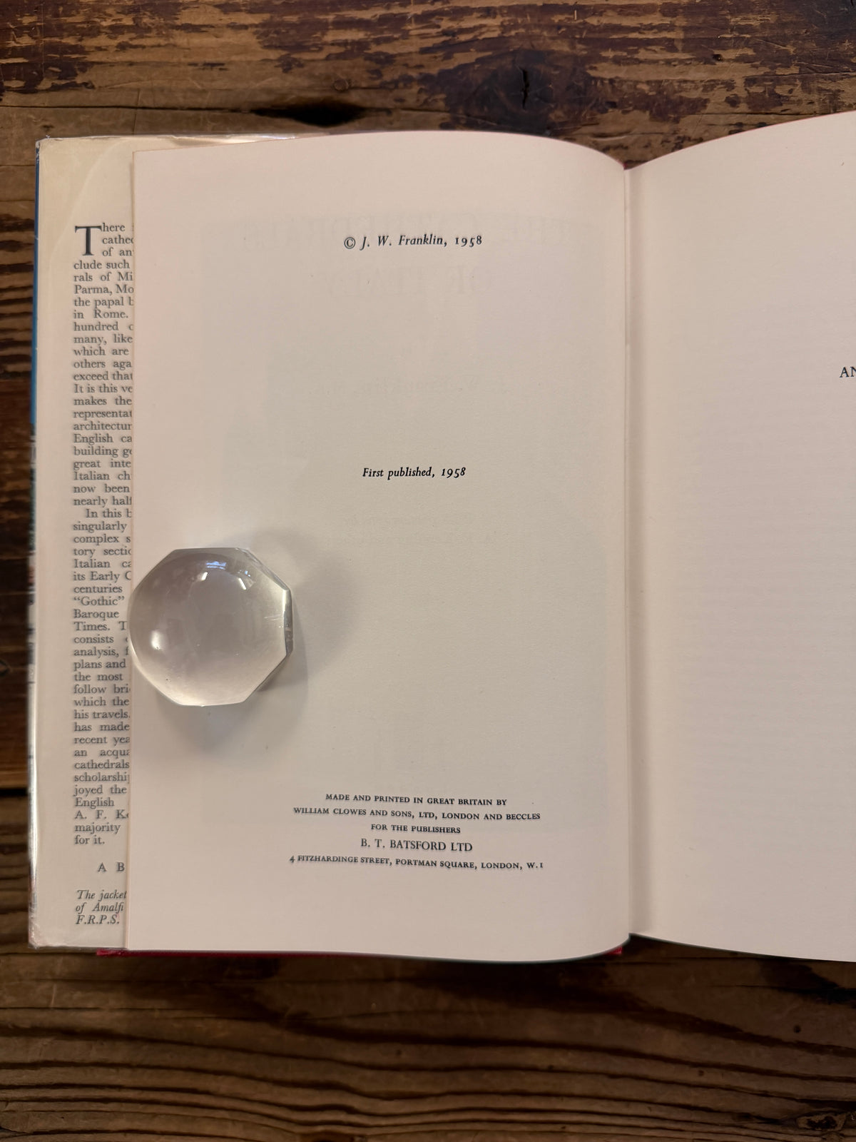Open book with the title 'The Cathedrals of Italy' by J.W. Franklin on a wooden surface