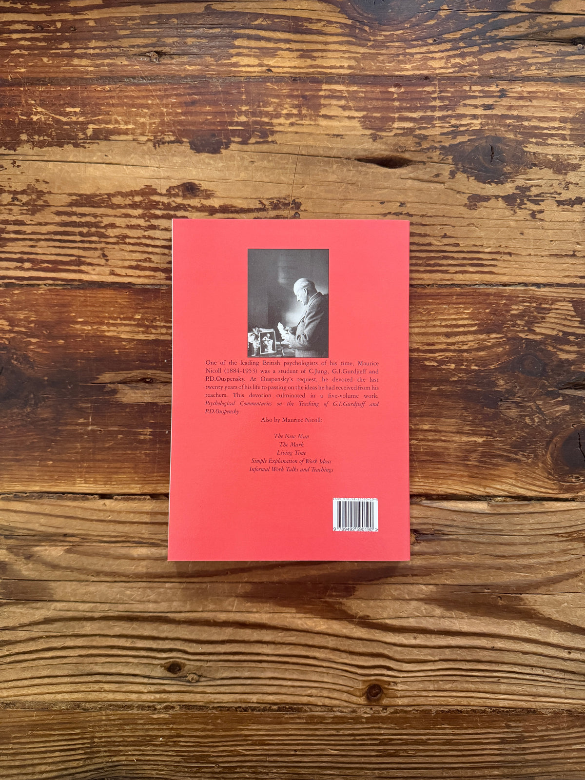 Back cover of book with the title Selections from meetings 1953' by Maurice Nicoll on a wooden surface