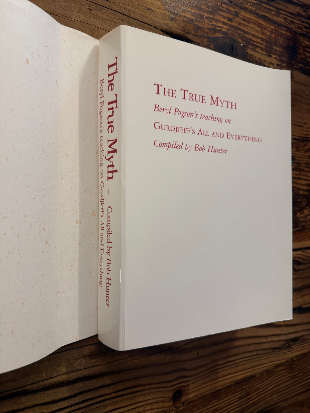 Front cover and spine without dust jacket of book titled 'The True Myth' by Bob Hunter on a wooden surface