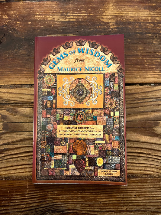 frontcover of book titled 'Gems of Wisdom' by Maurice Nicoll on a wooden surface