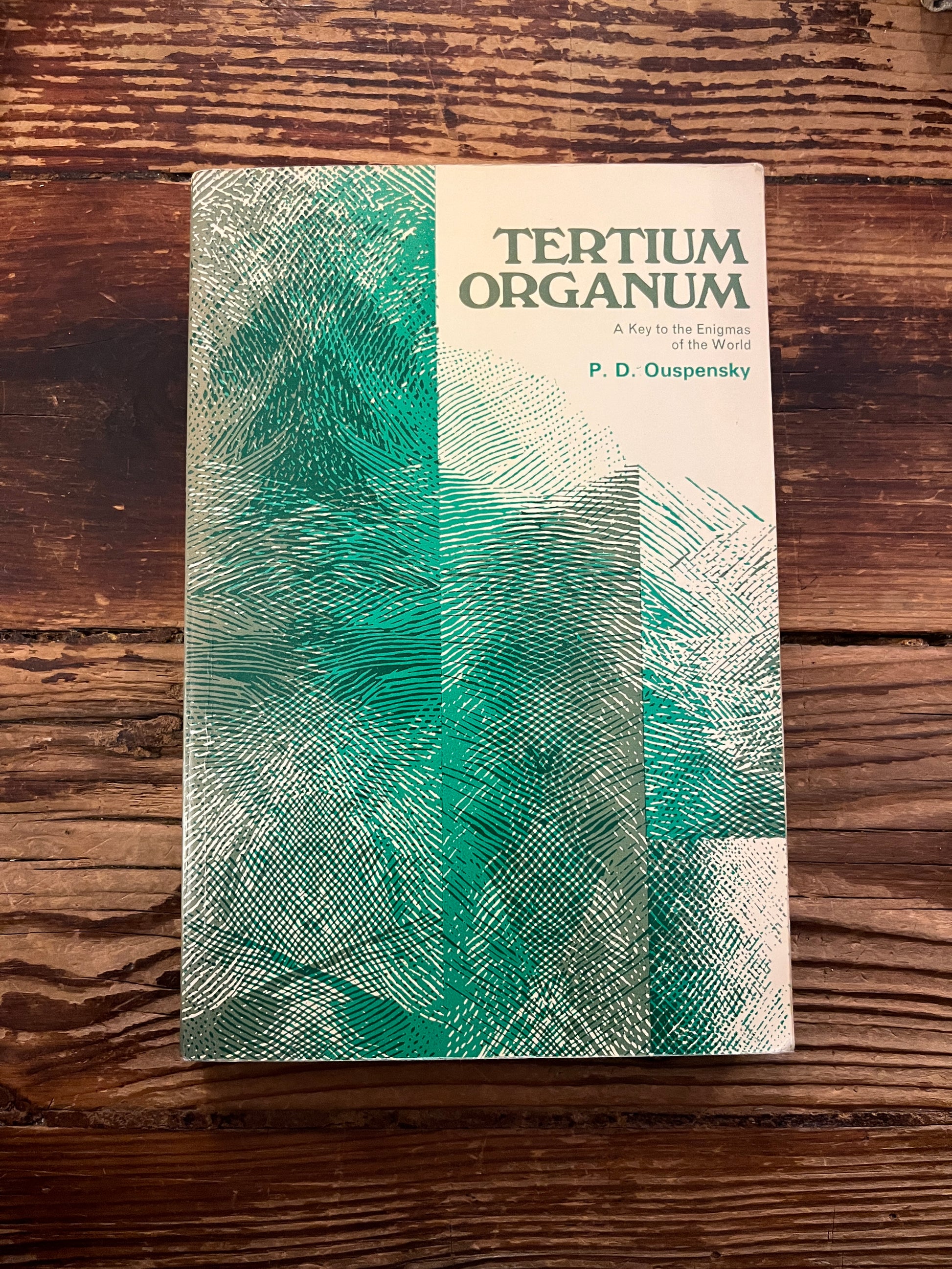 Front cover of book titled 'Tertium Organum' by P.D. Ouspensky on a wooden surface