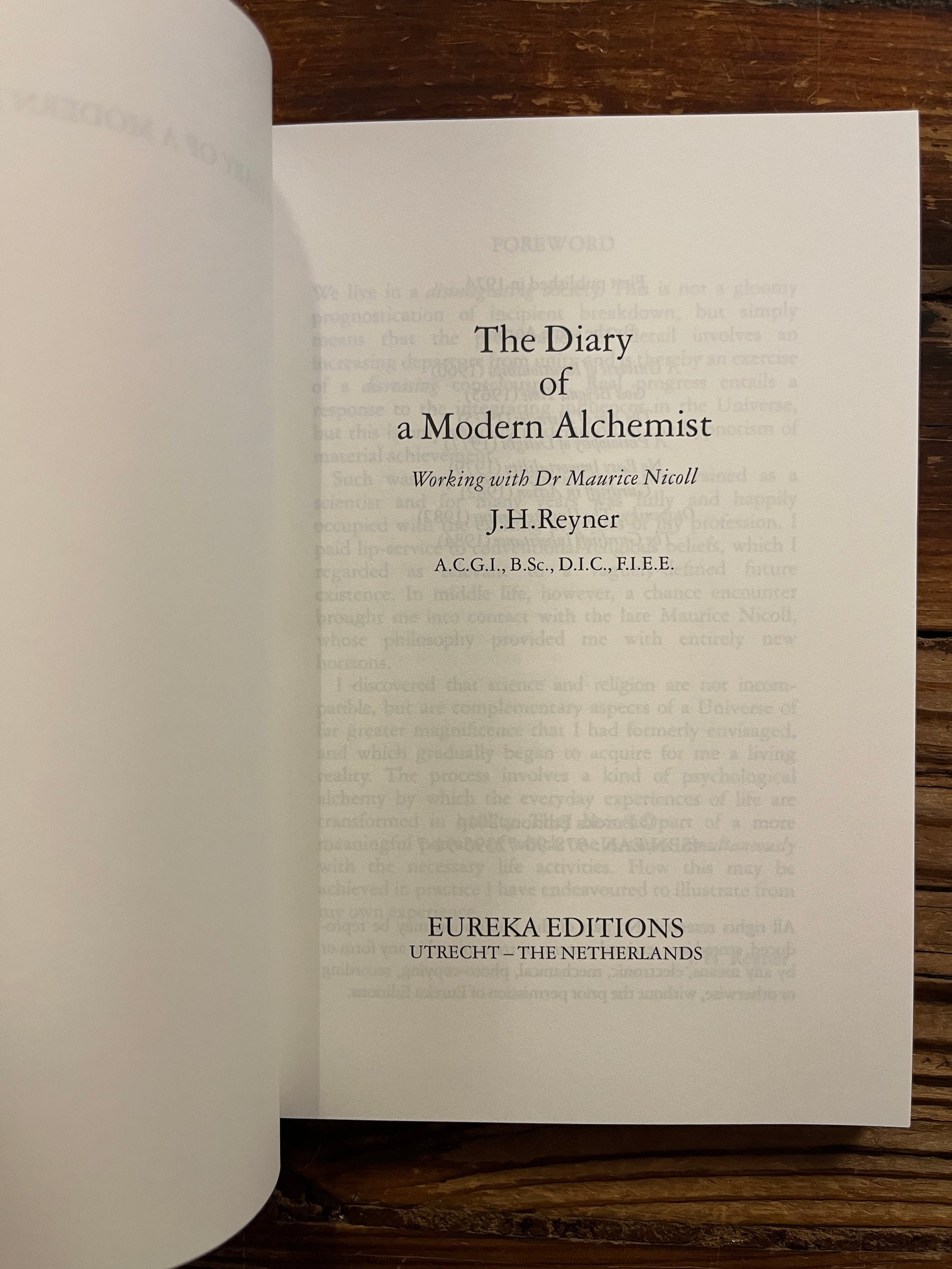 Open book showing the title page, book is titled 'the Diary of a modern Alchemist' by J.H. Reyner 